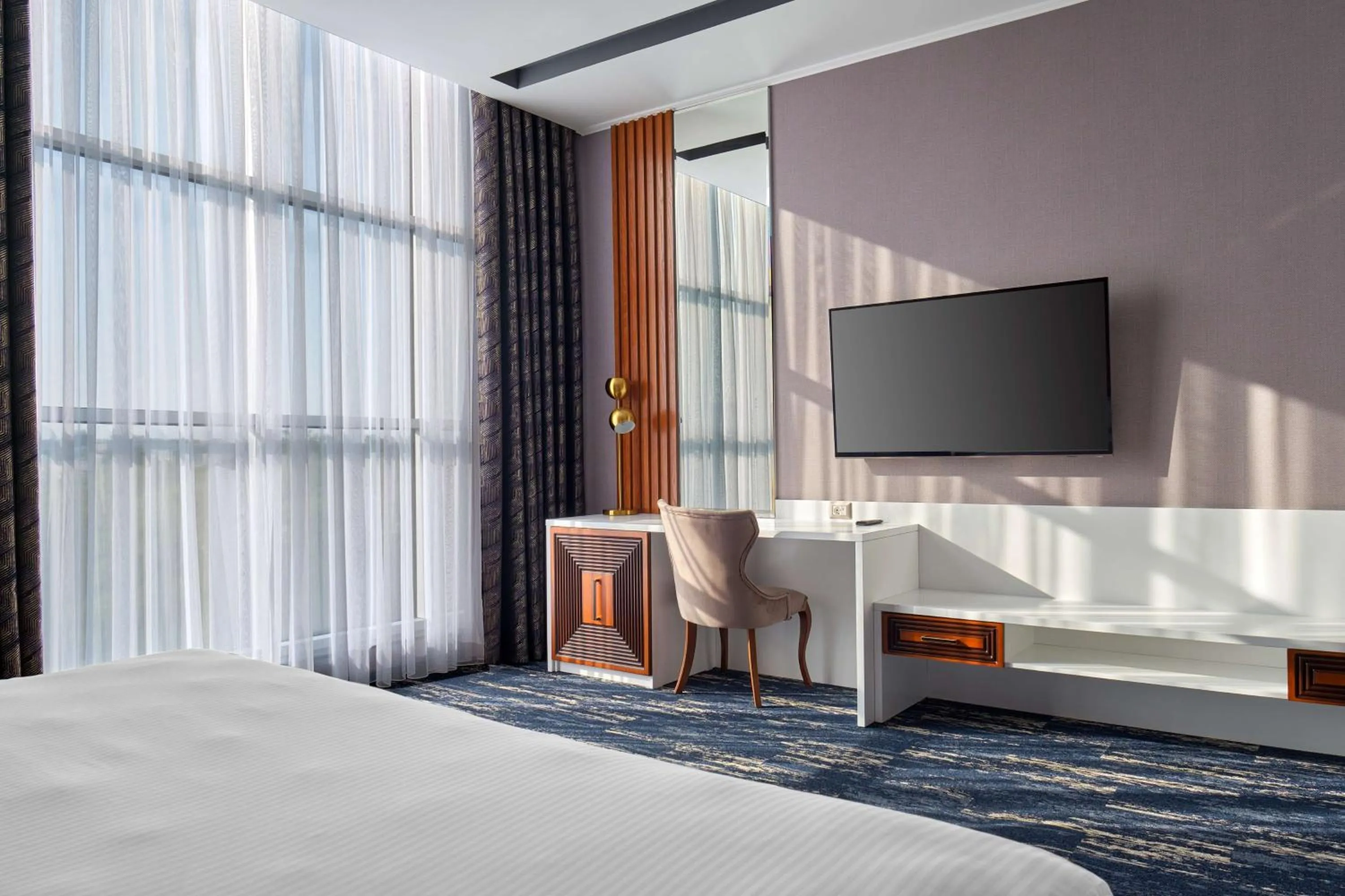 Communal lounge/ TV room, Bed in Panarams Tashkent Hotel, a member of Radisson Individuals