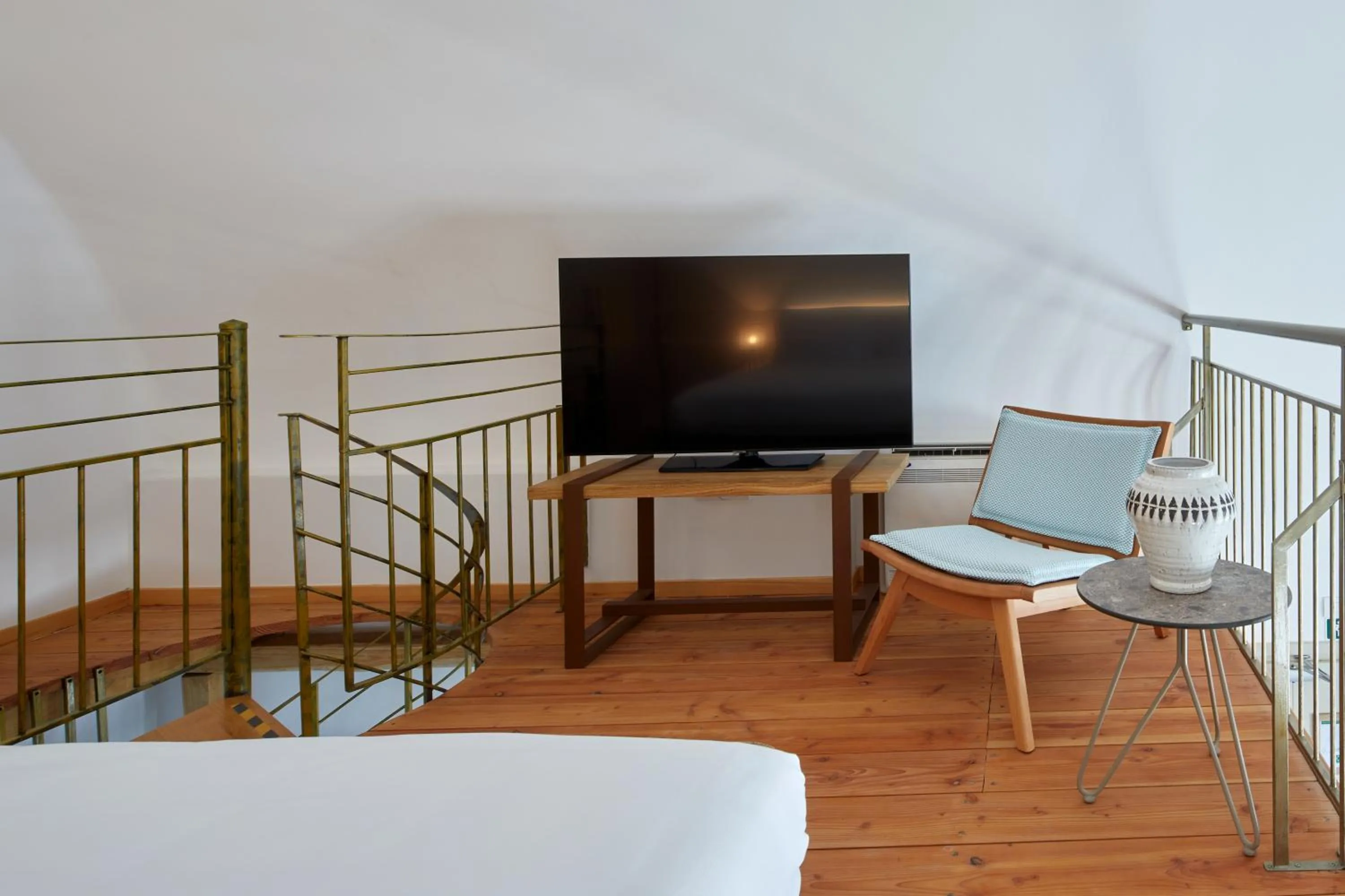 Bed in Sea Breeze Santorini Beach Resort, Curio By Hilton