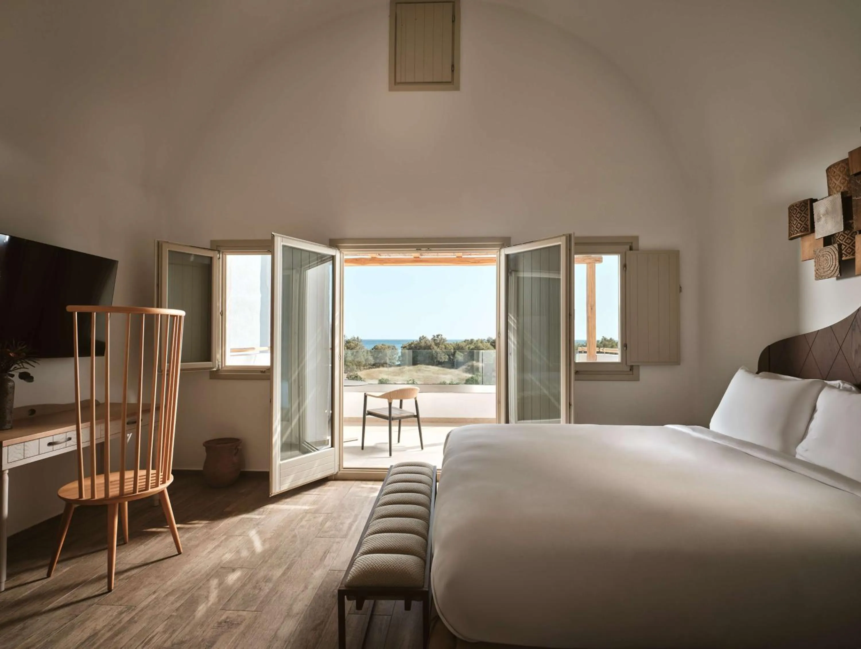 Bed in Sea Breeze Santorini Beach Resort, Curio By Hilton