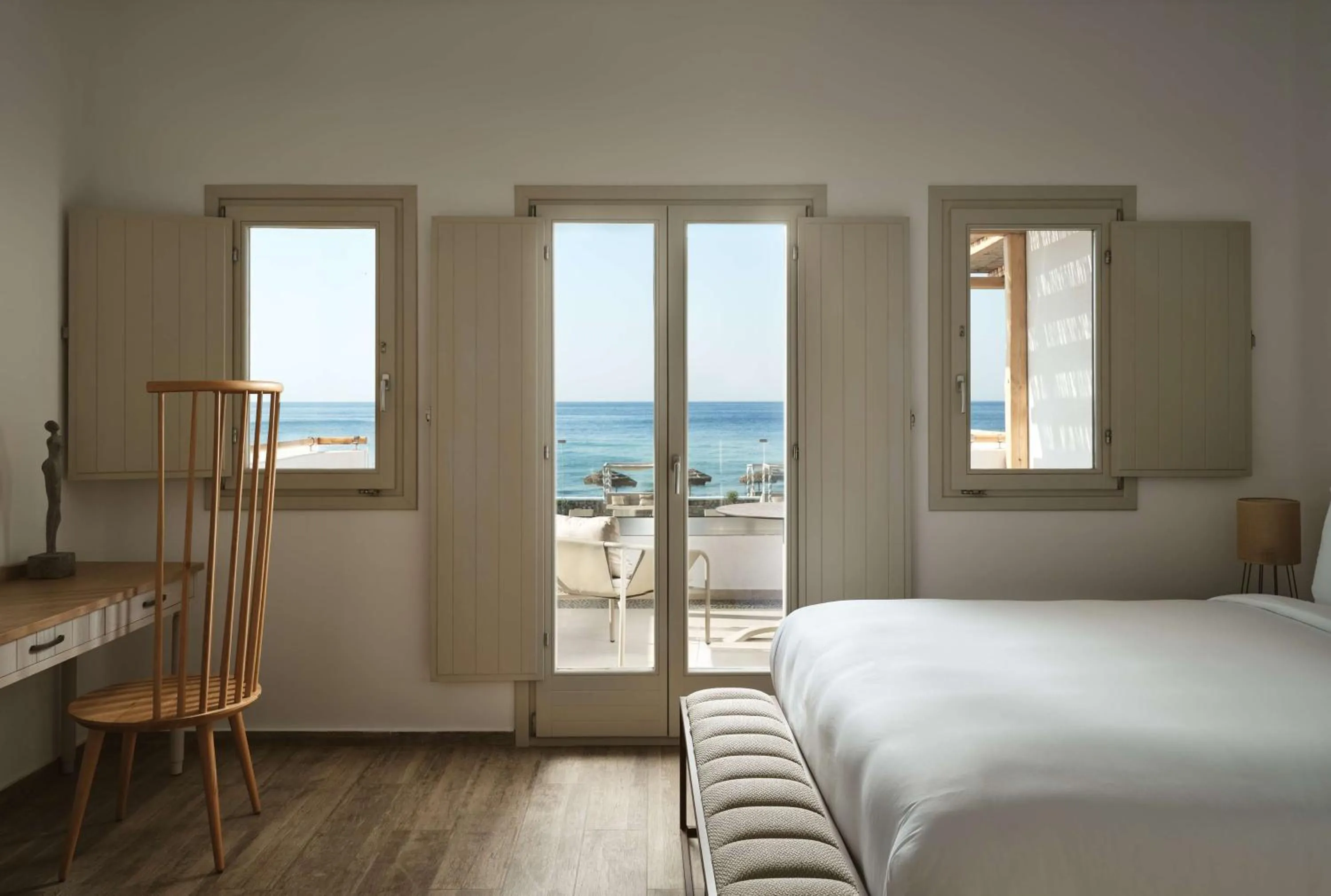 Bed in Sea Breeze Santorini Beach Resort, Curio By Hilton