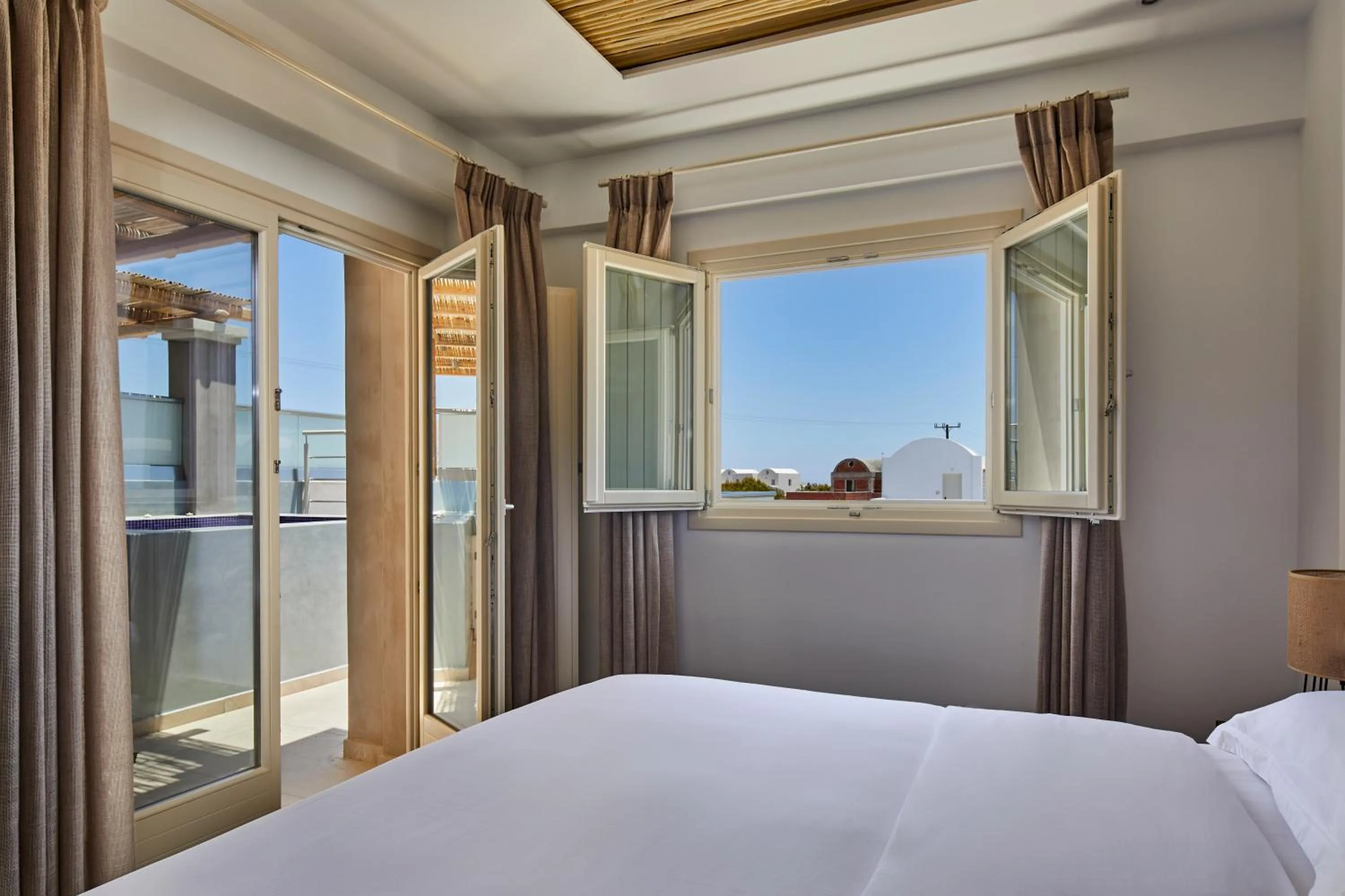 Bed in Sea Breeze Santorini Beach Resort, Curio By Hilton