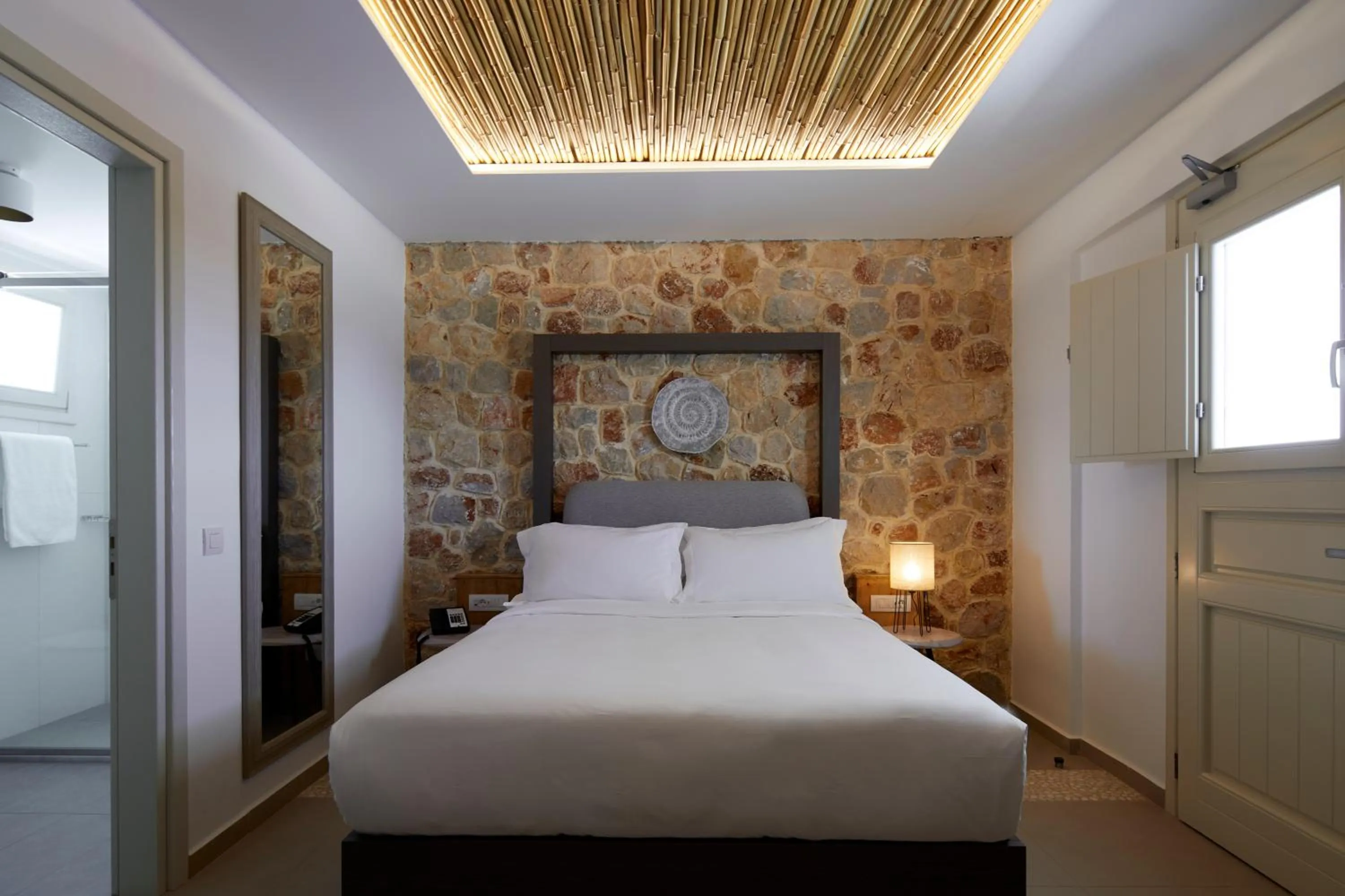 Bed in Sea Breeze Santorini Beach Resort, Curio By Hilton