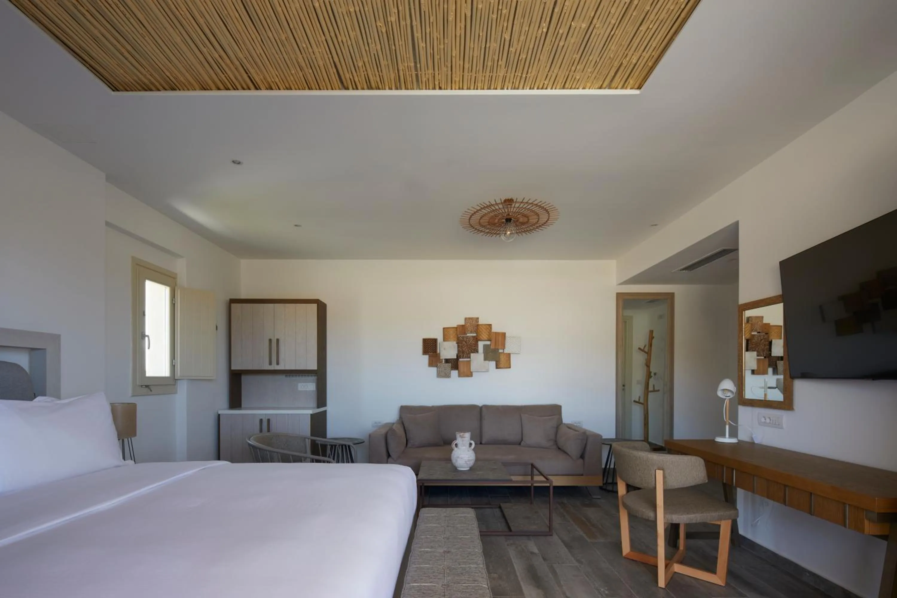 Bed in Sea Breeze Santorini Beach Resort, Curio By Hilton