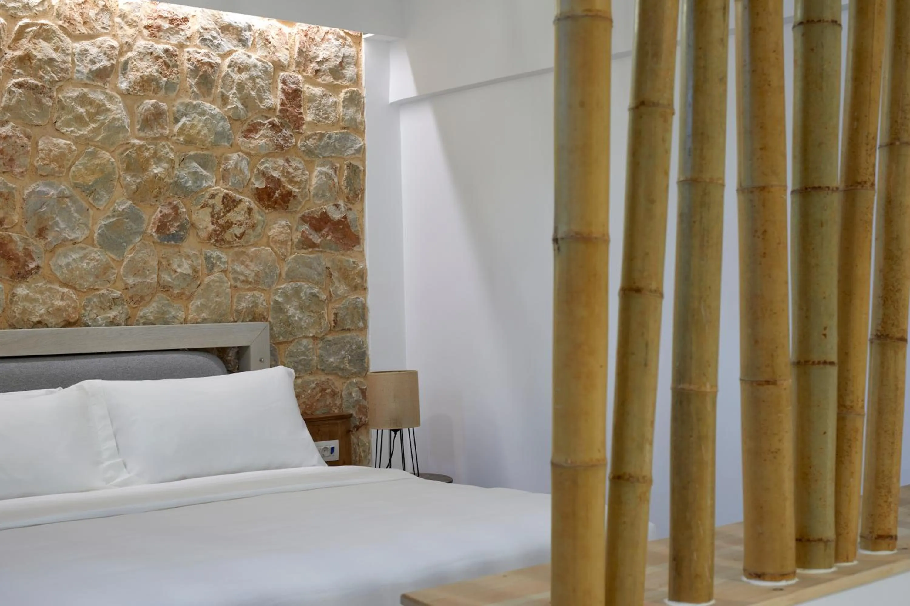 Bed in Sea Breeze Santorini Beach Resort, Curio By Hilton