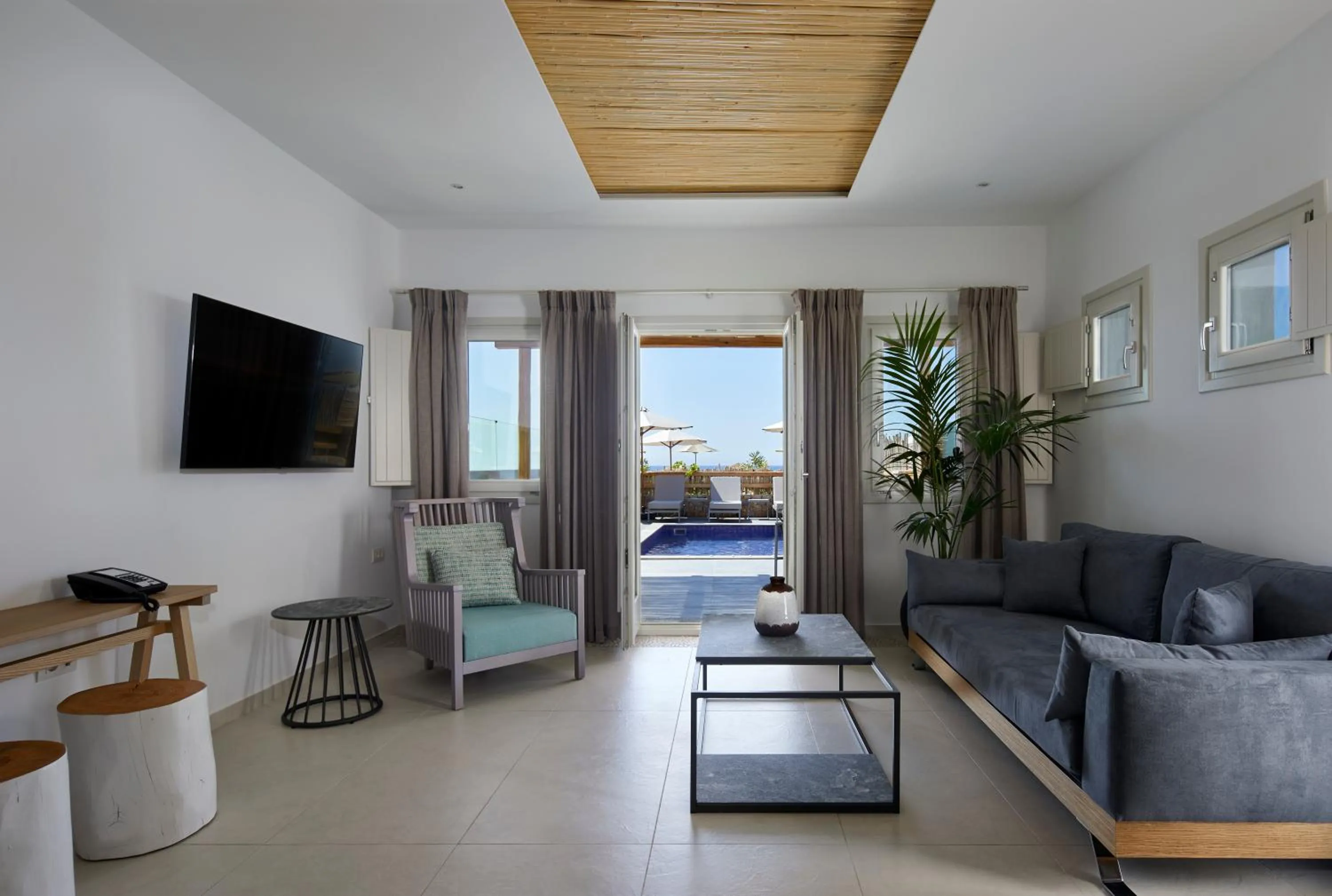 TV and multimedia in Sea Breeze Santorini Beach Resort, Curio By Hilton