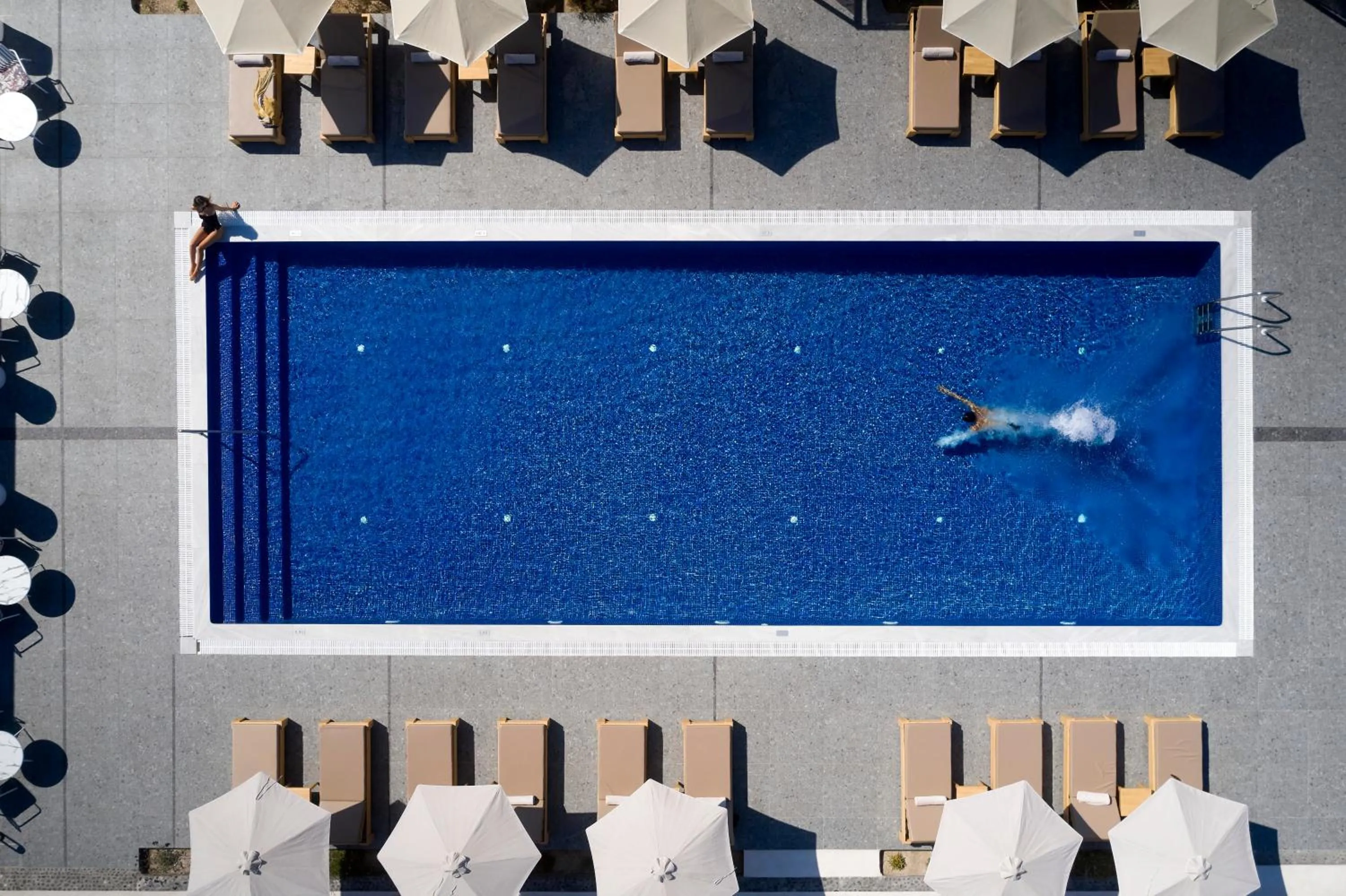 Guests in Sea Breeze Santorini Beach Resort, Curio By Hilton