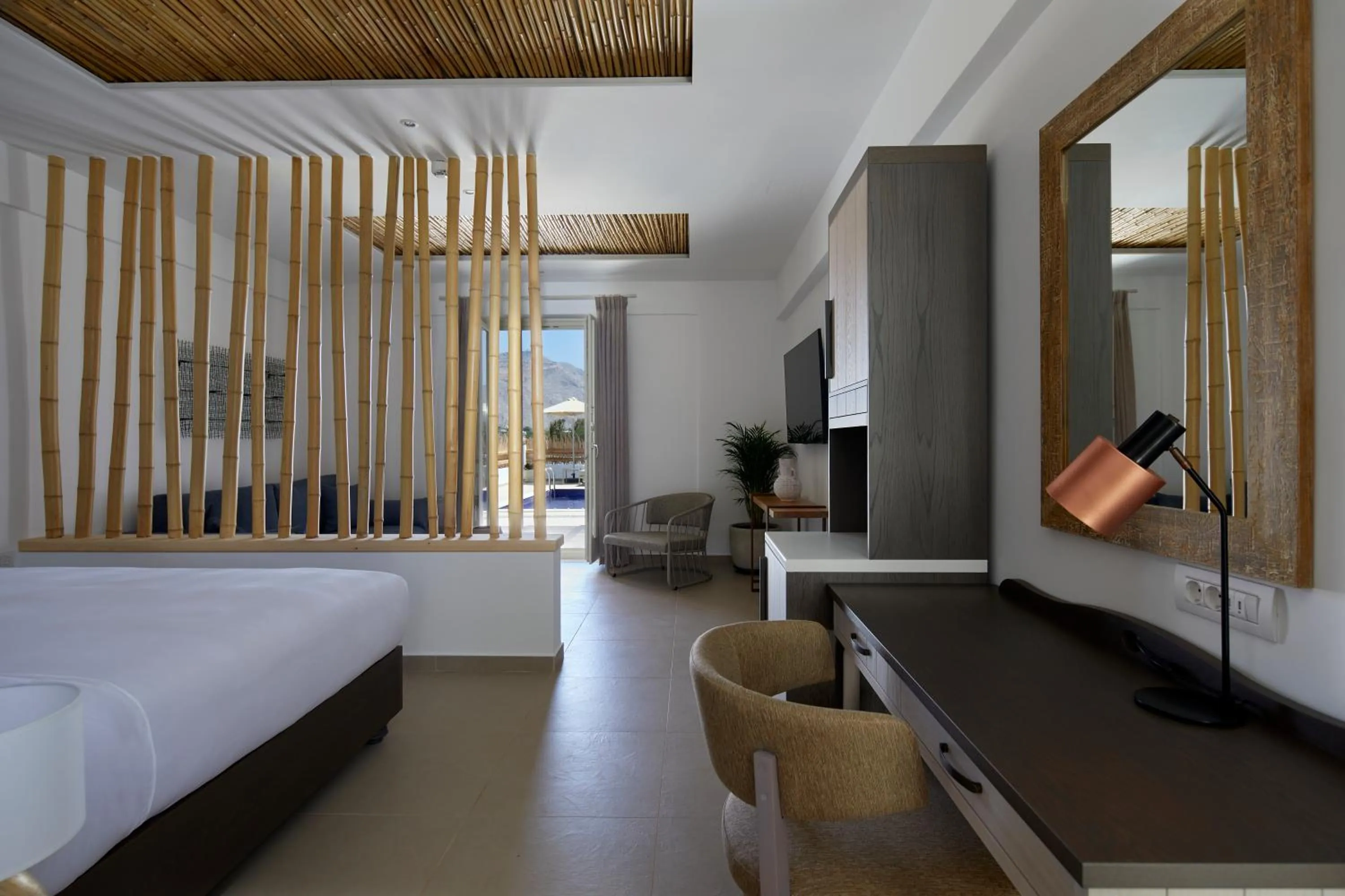 Bed in Sea Breeze Santorini Beach Resort, Curio By Hilton