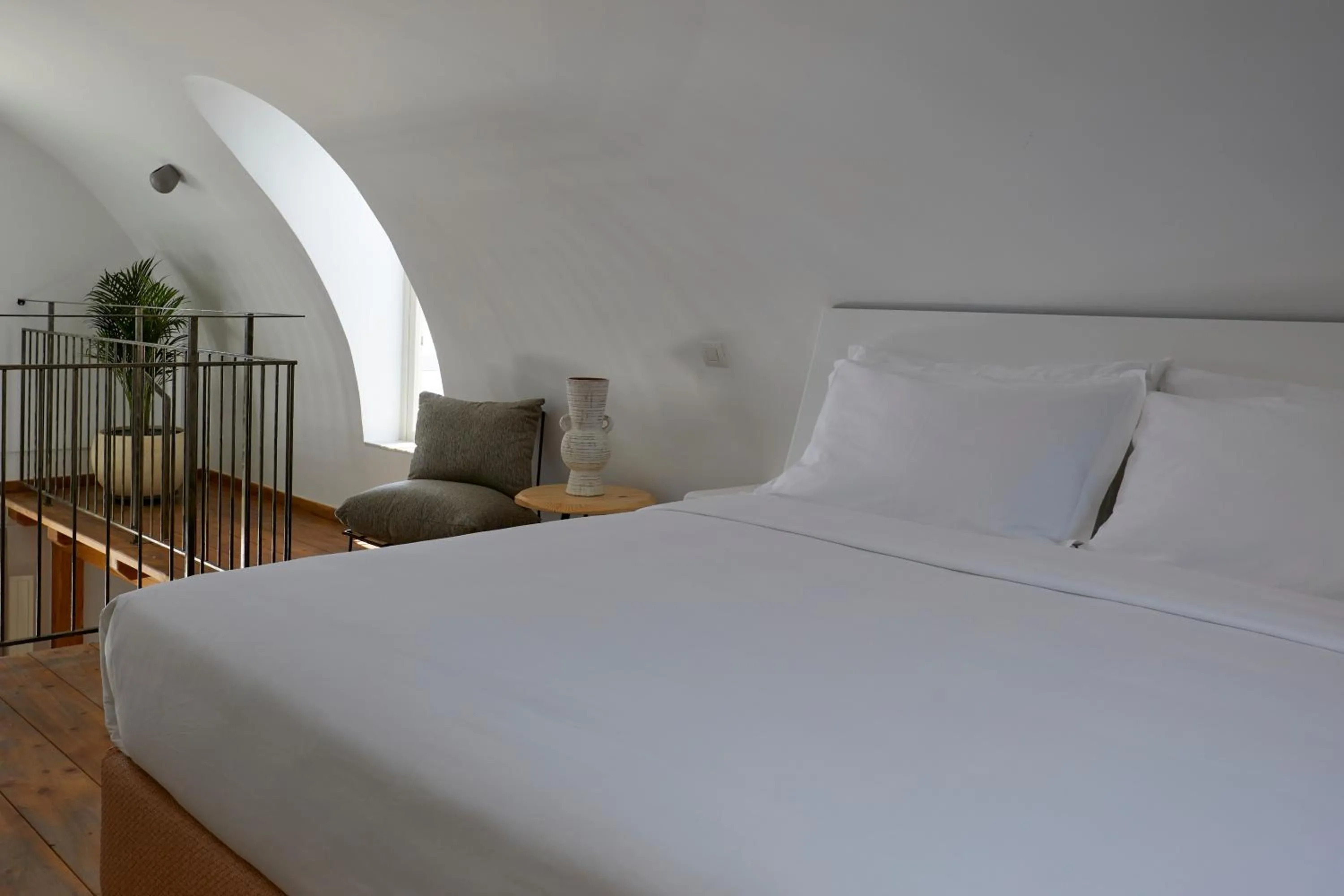 Bed in Sea Breeze Santorini Beach Resort, Curio By Hilton