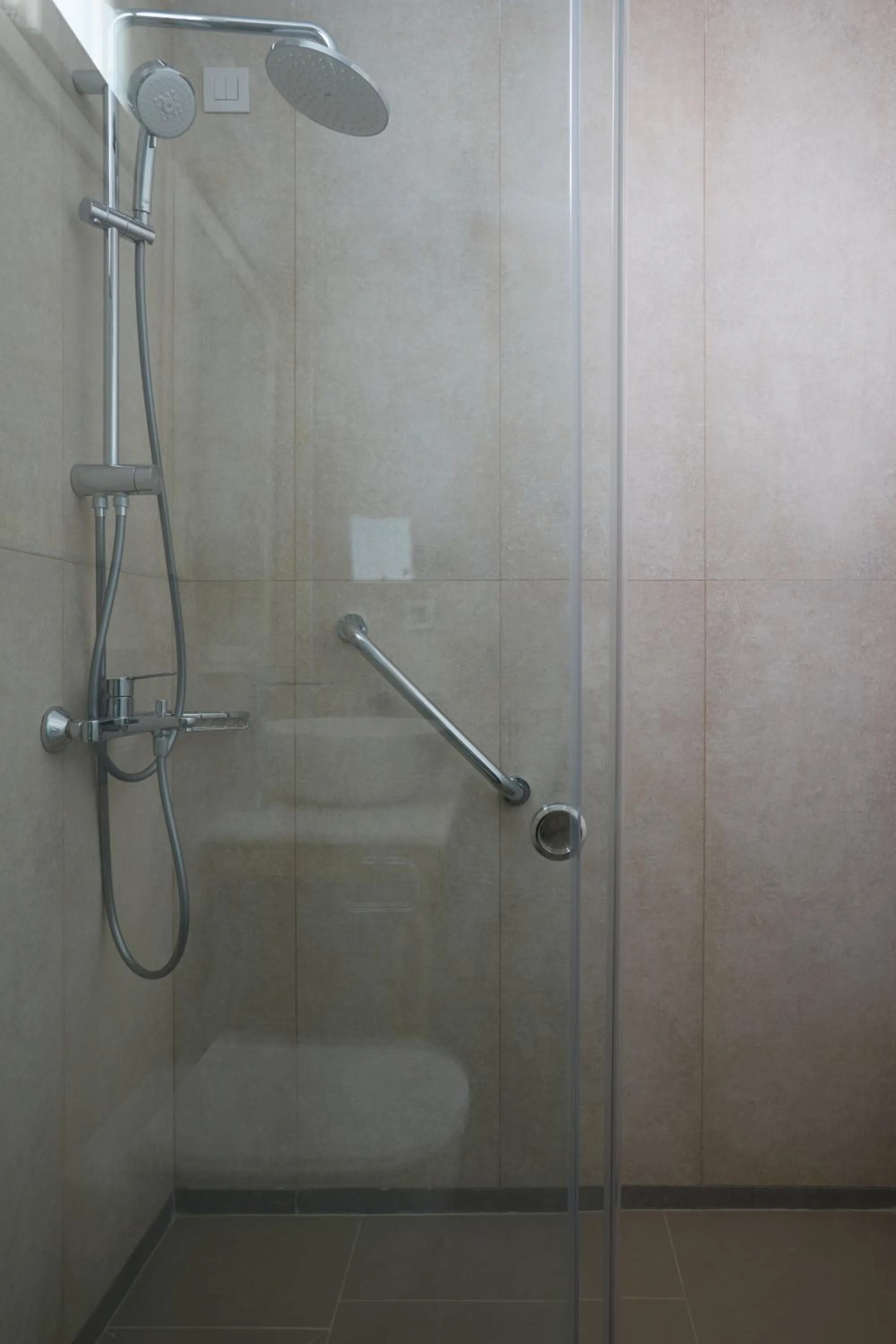 Shower in Sea Breeze Santorini Beach Resort, Curio By Hilton