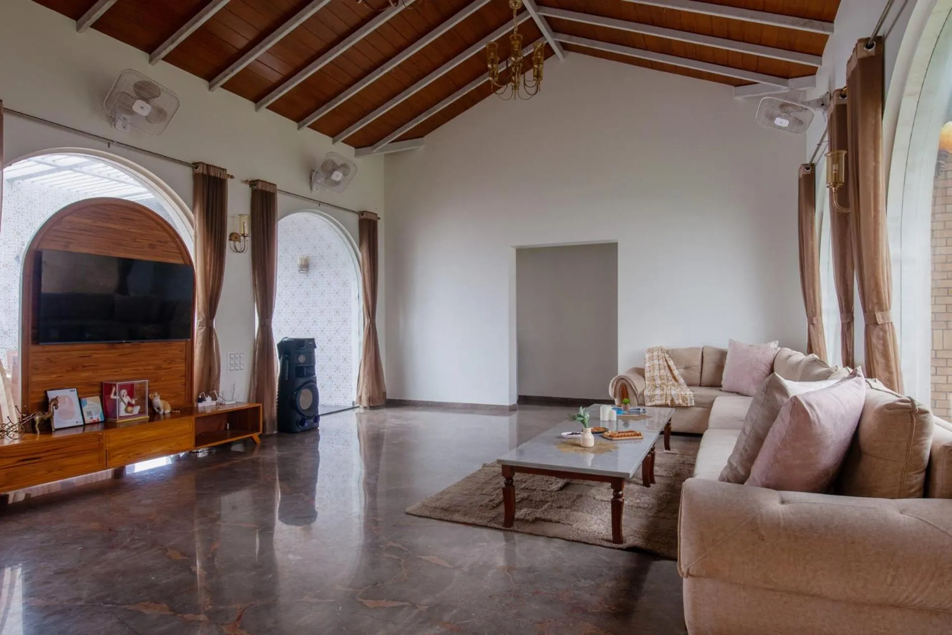 Living room in Lake Arches by StayVista - Lakeside villa with Infinity pool, Gazebo & Modern Greek interiors