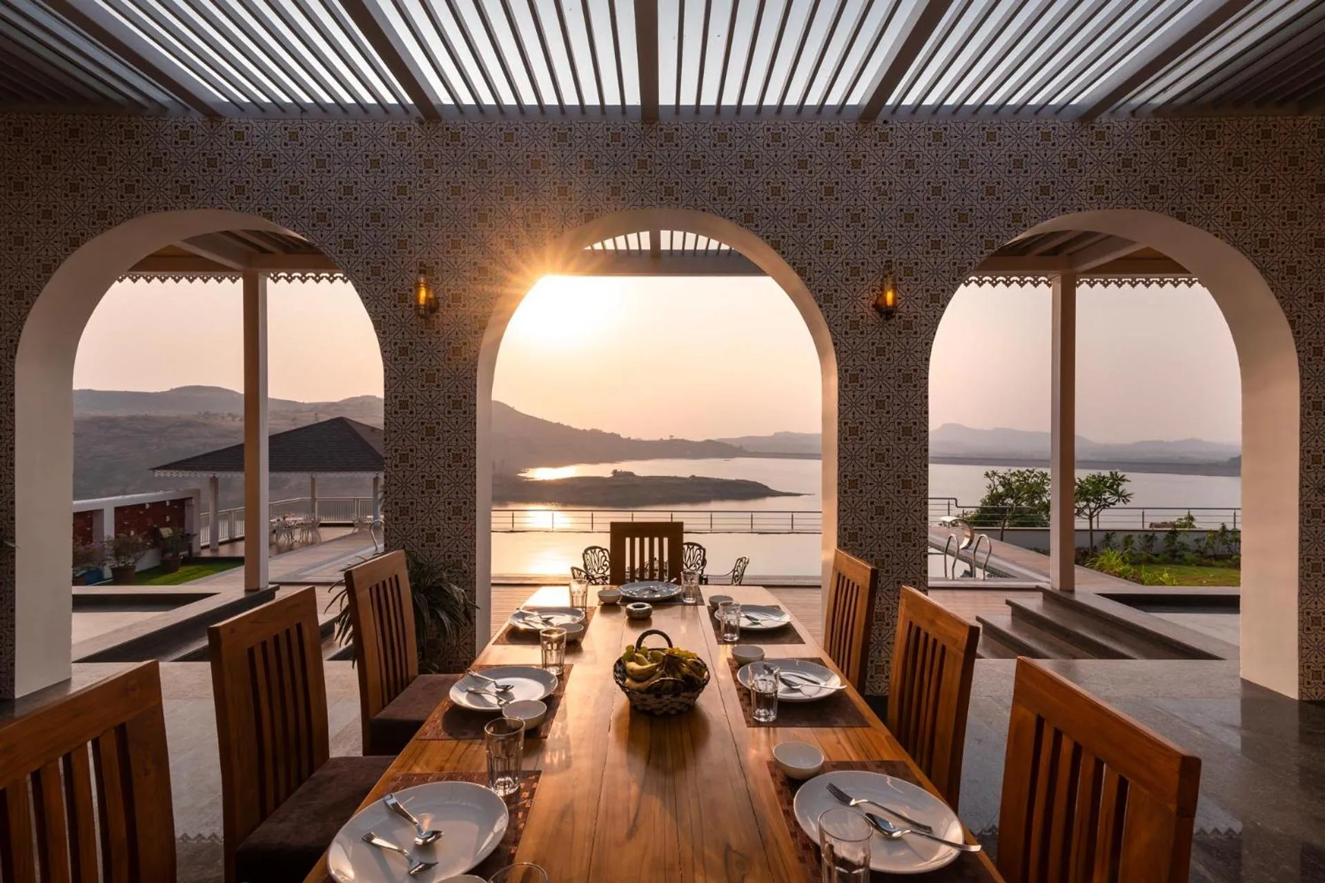 Dining area in Lake Arches by StayVista - Lakeside villa with Infinity pool, Gazebo & Modern Greek interiors