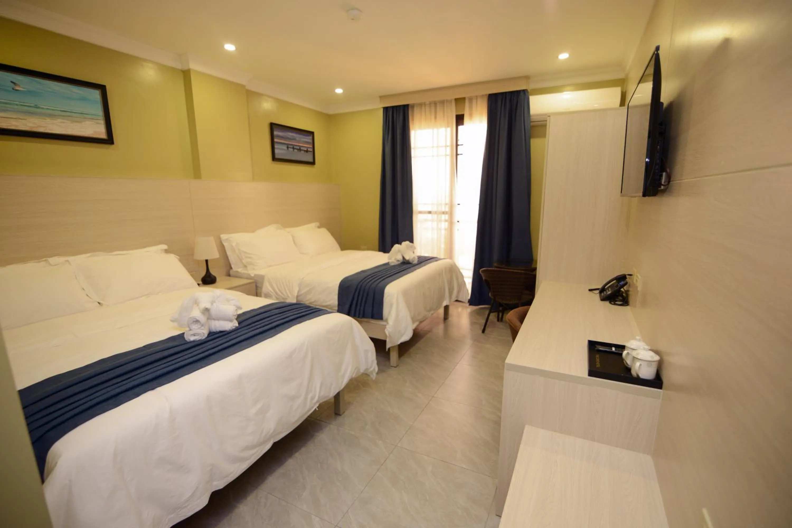 Photo of the whole room, Bed in The Caye Hotel Caye Caulker