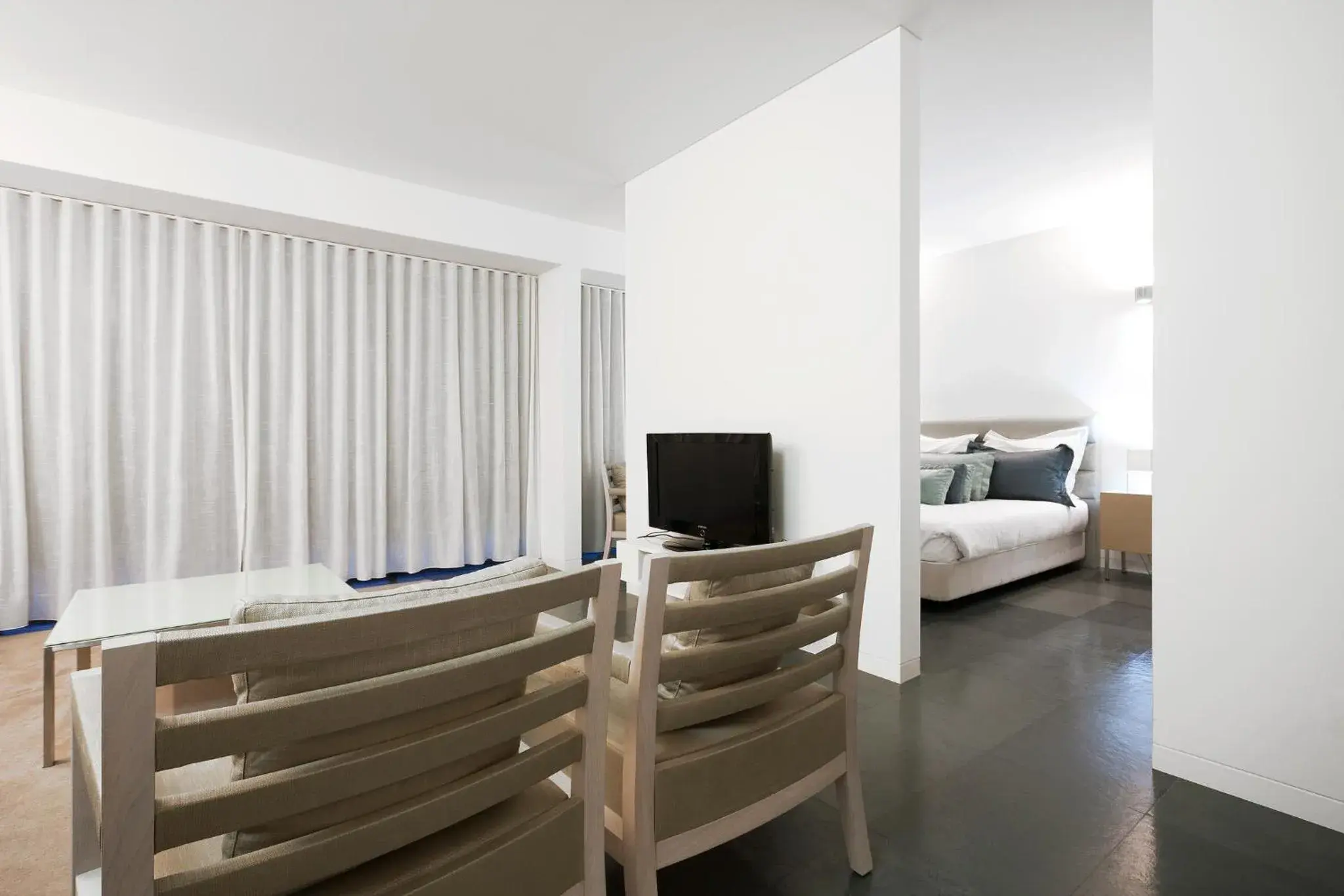 Living room, Bed in Troia Residence by The Editory - Apartamentos Ácala Living room, Bed in Troia Residence by The Editory - Apartamentos Ácala