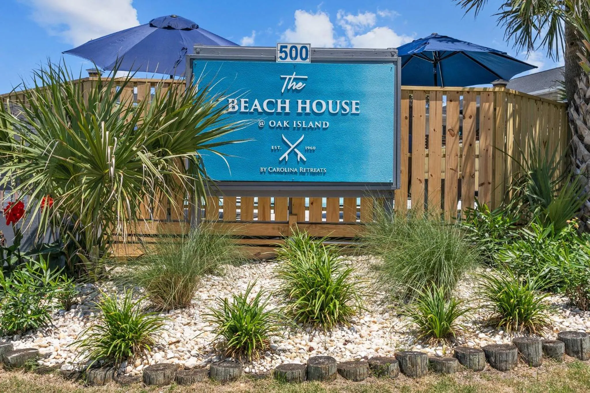Property logo or sign in The Beach House at Oak Island by Carolina Resorts