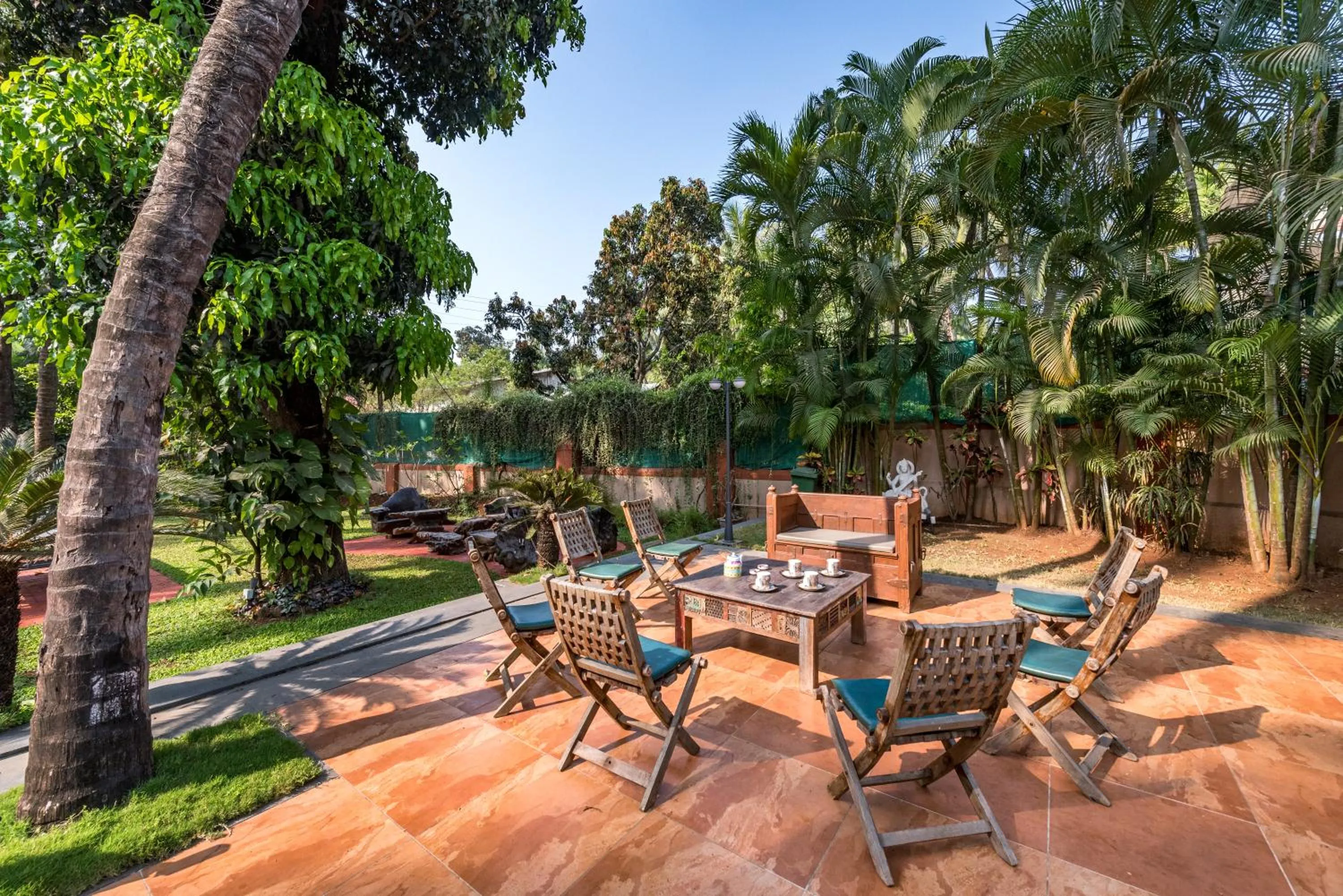 Patio in SaffronStays Casa Del Palms - 8BR luxury pool villa with gazebo, pickleball, bar & lawns near Nagaon Beach