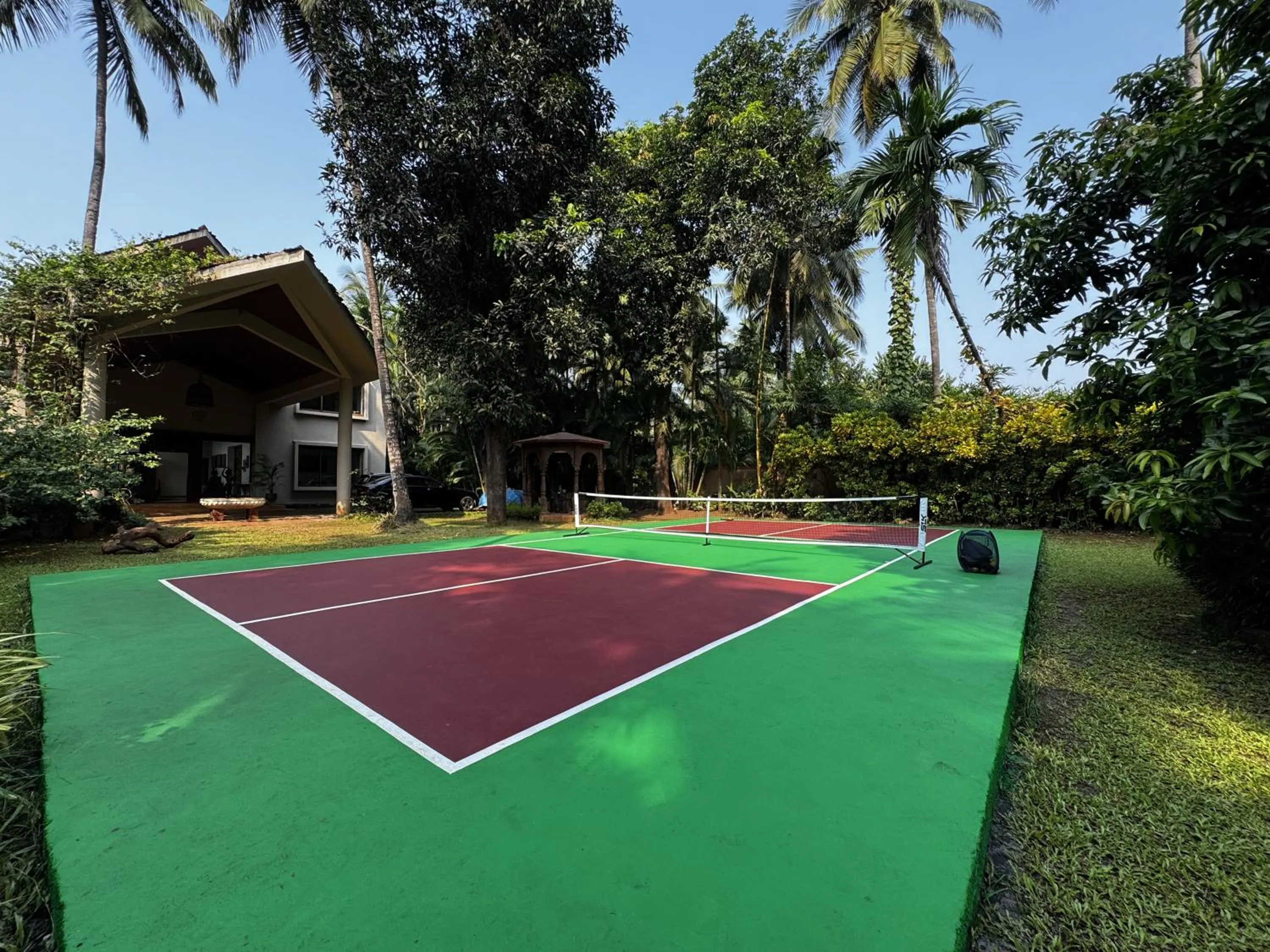 Day in SaffronStays Casa Del Palms - 8BR luxury pool villa with gazebo, pickleball, bar & lawns near Nagaon Beach