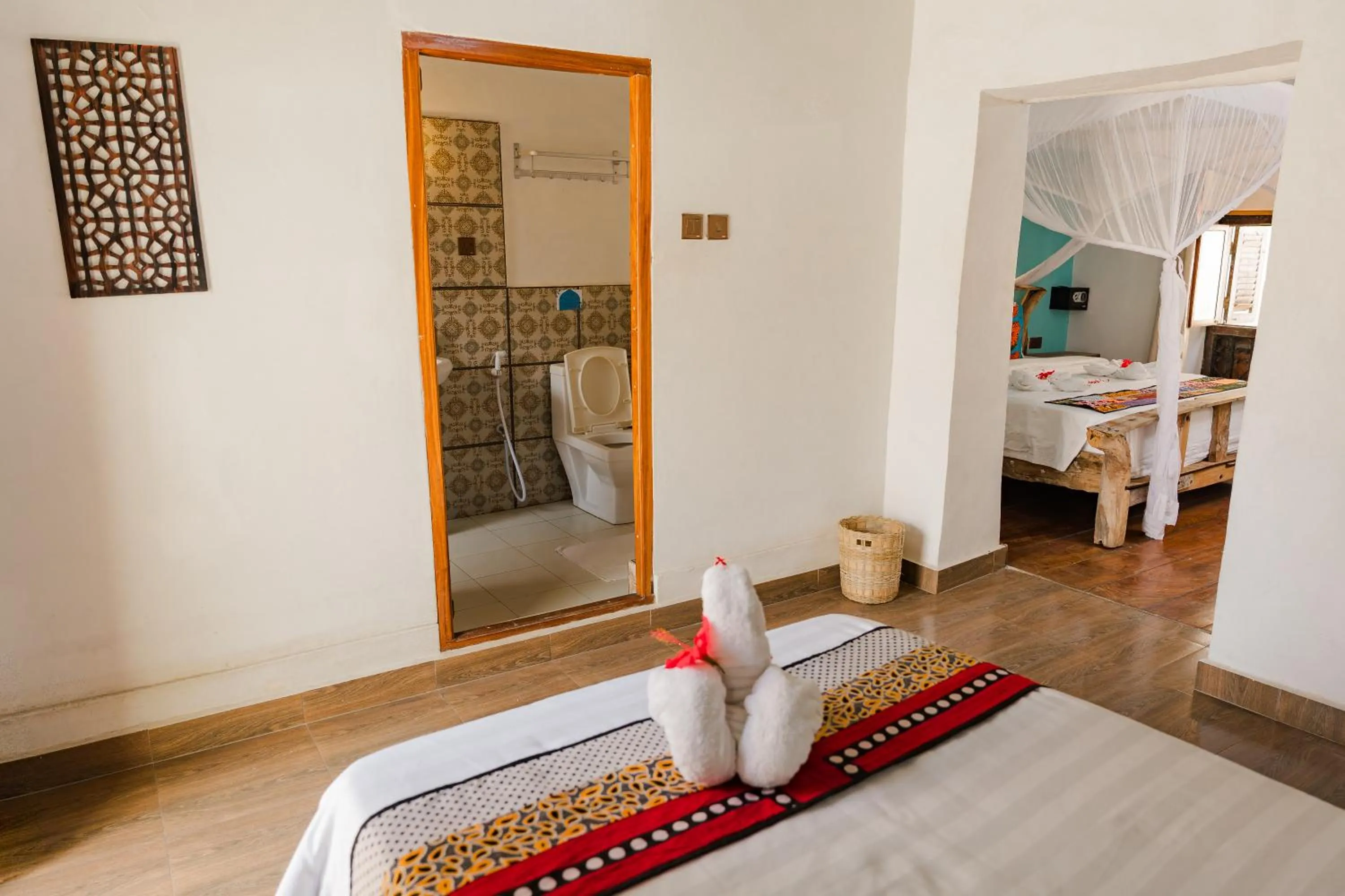 Toilet, Bed in Emerald Palm Courtyard Hotel