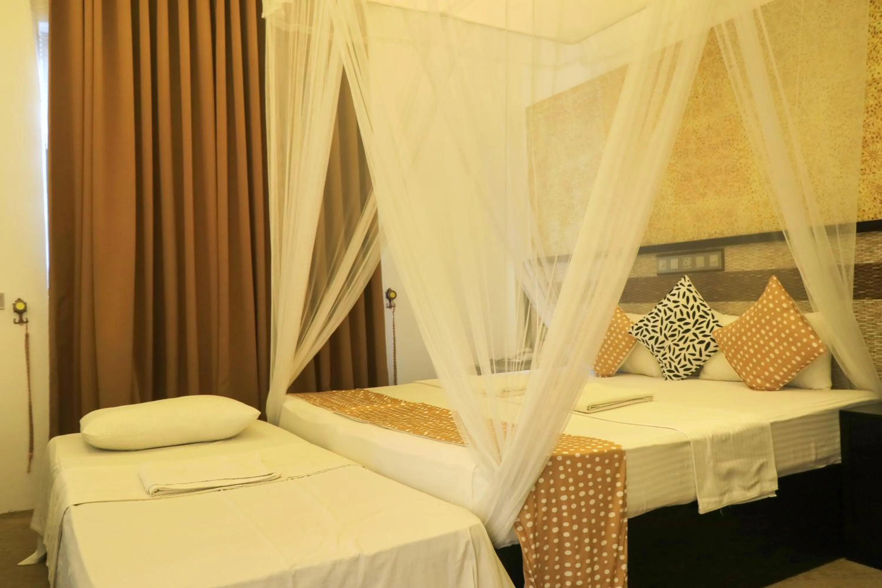 Bed in Thissa Inn Hotel