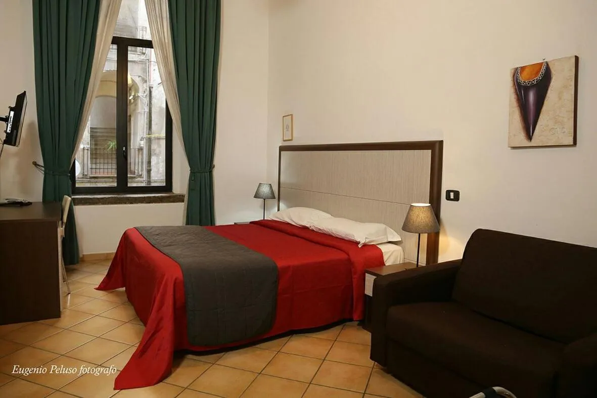 Bed in Caravaggio Hotel