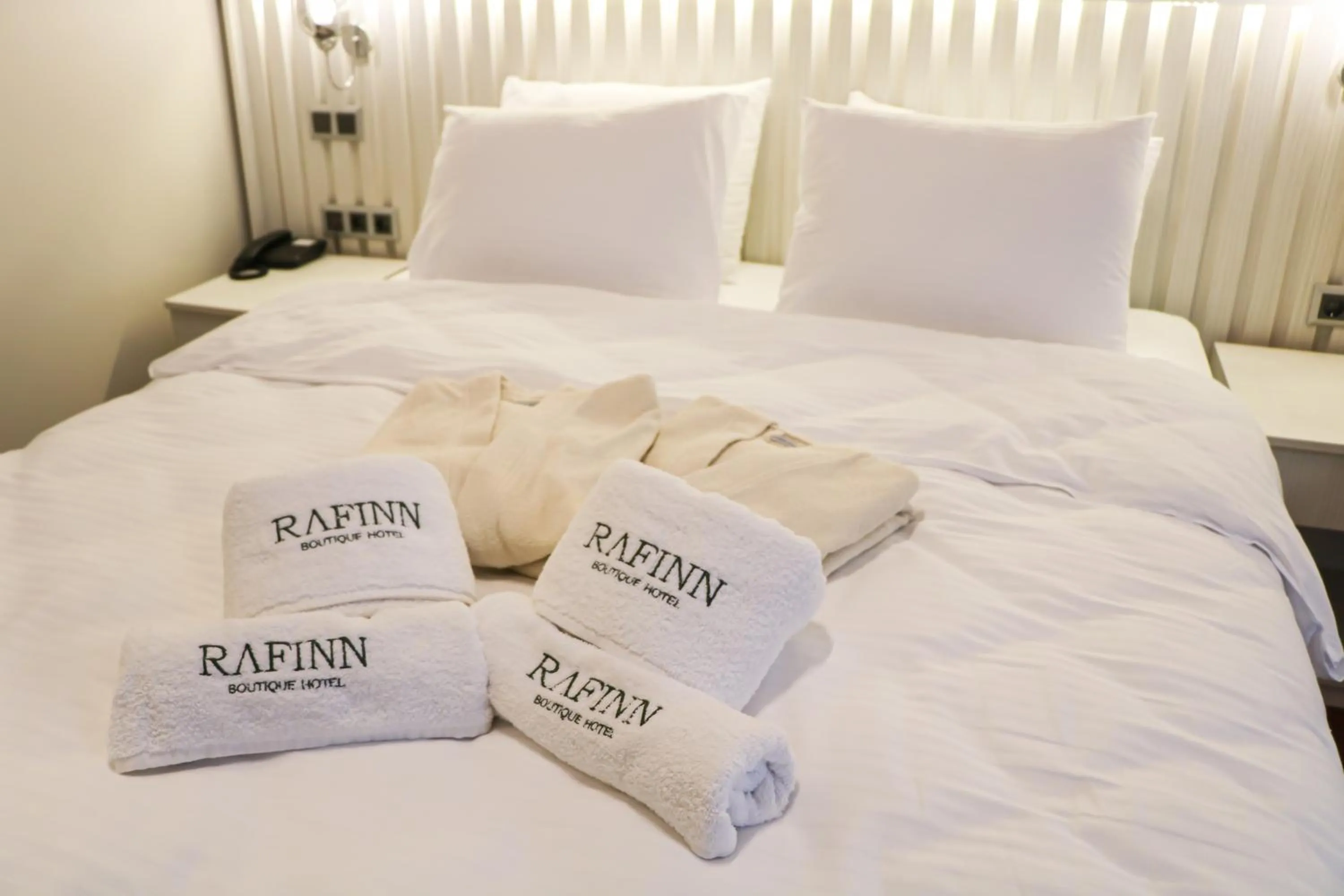 towels, Bed in Rafinn Hotel