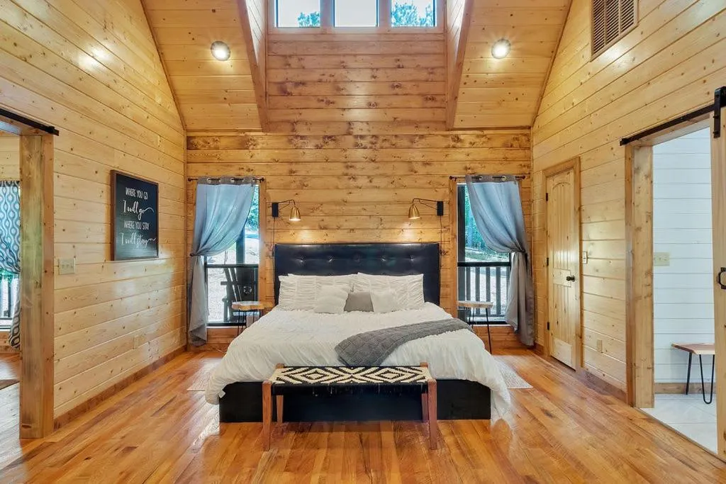 Bed in Gorgeous Idyllic Cabin w Hot Tub and Fire Pit Quittin Time is Secluded Romantic Oasis w Luxury Bathroom Double Shower and Bathtub Foosball Table