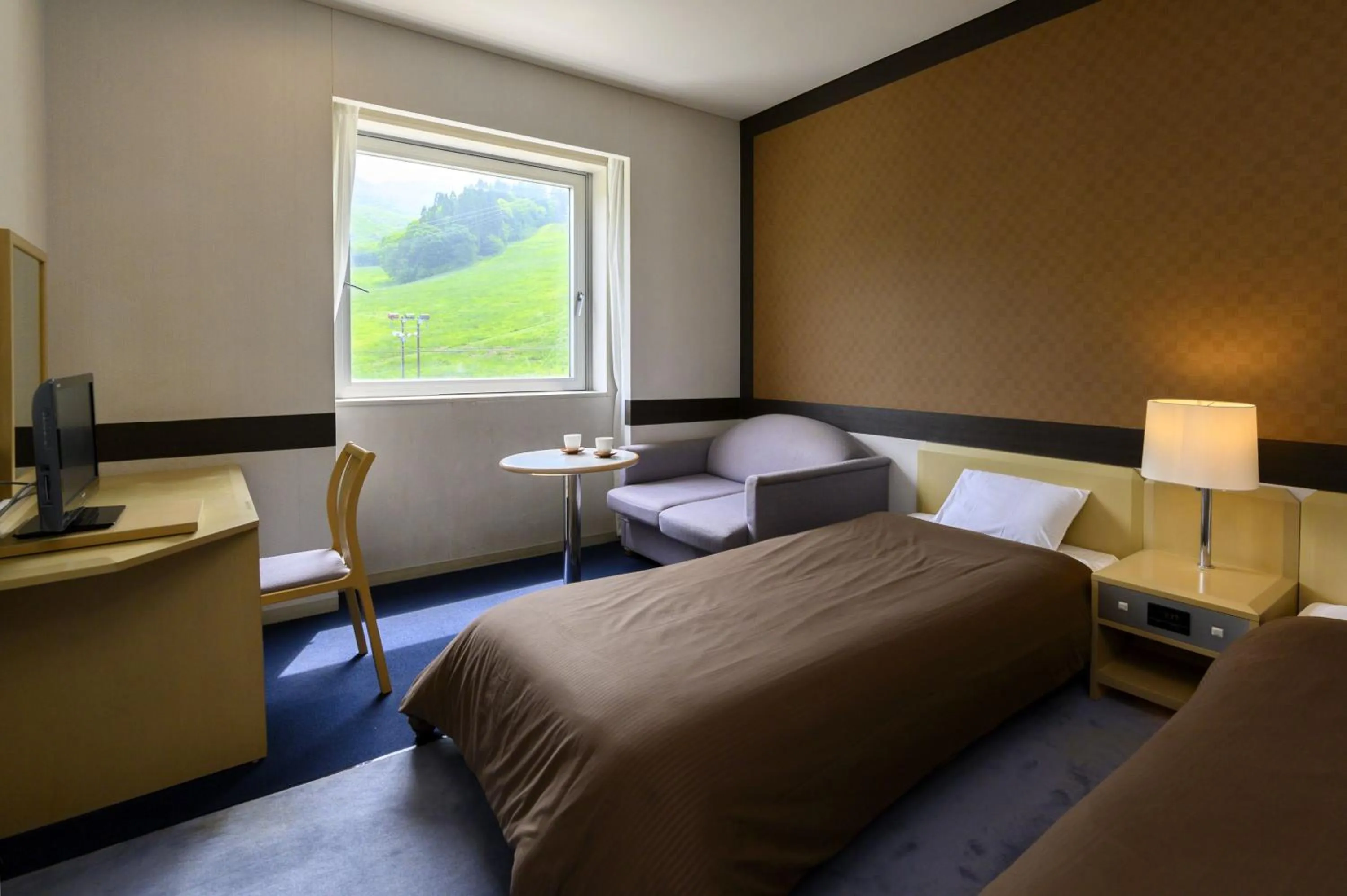 Bed in Takamiya Hotel Rurikura Resort