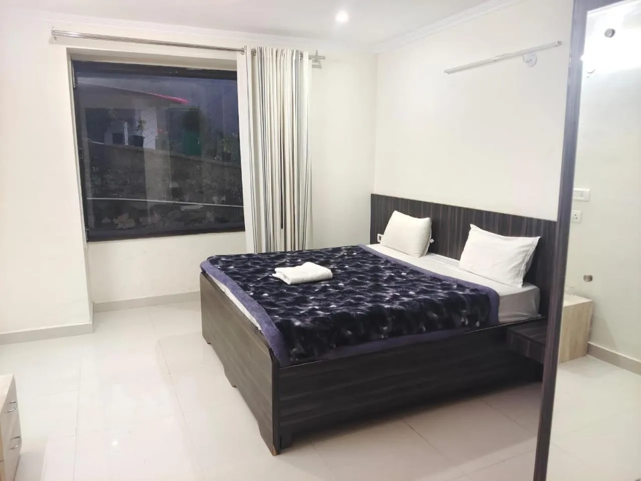 Bed in Just Naturals Wellness Resort Nainital