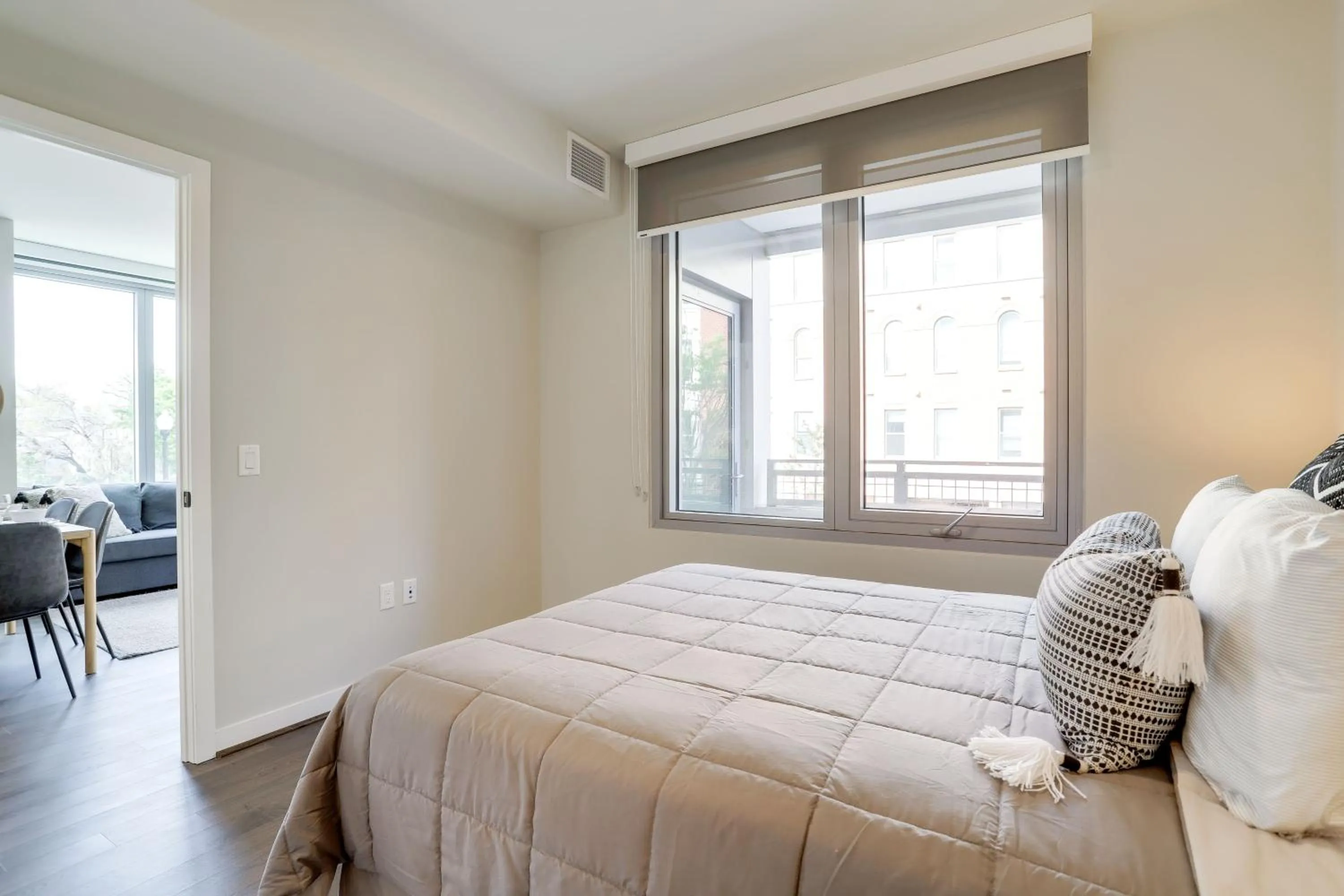 Bed in Stylish Condo at Clarendon with Rooftop Views