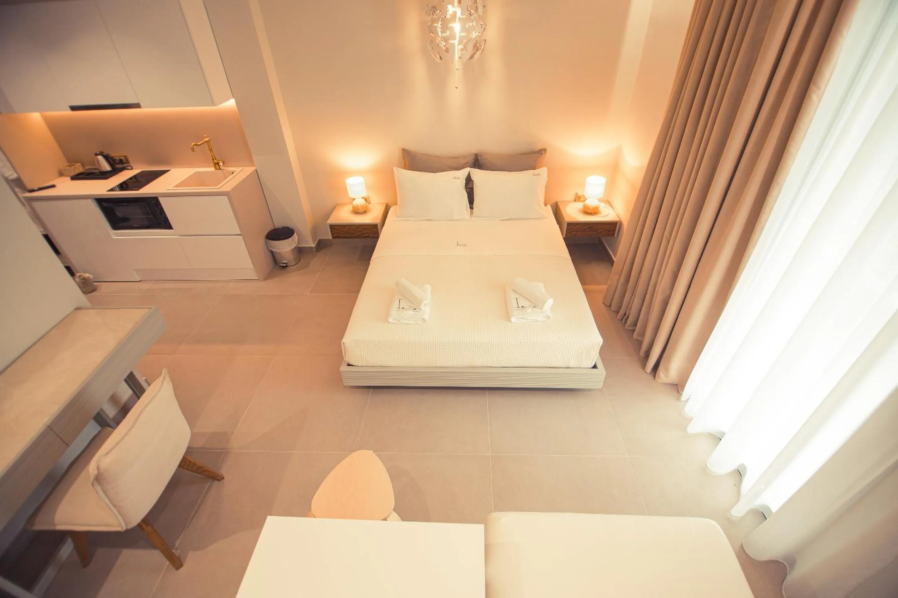 Bed in IO Luxury Pool & Hot Tub Suites