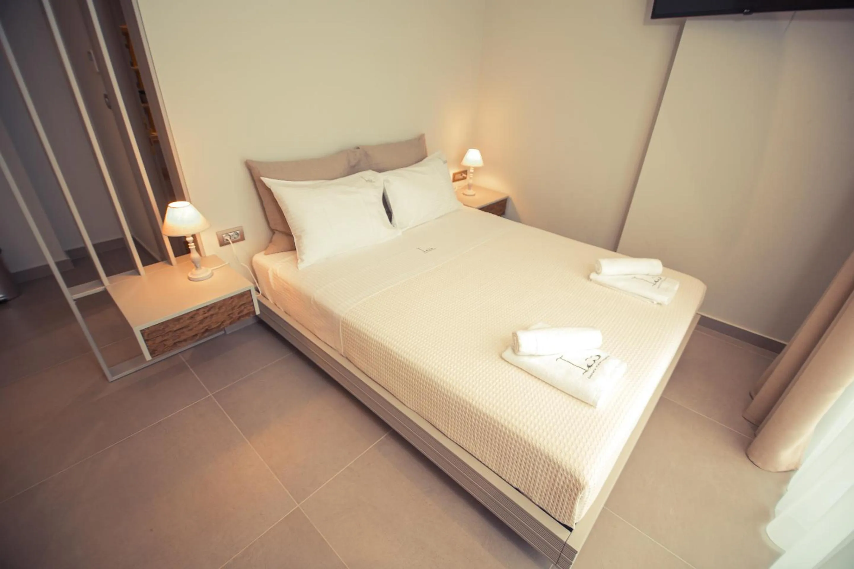 Bed in IO Luxury Pool & Hot Tub Suites