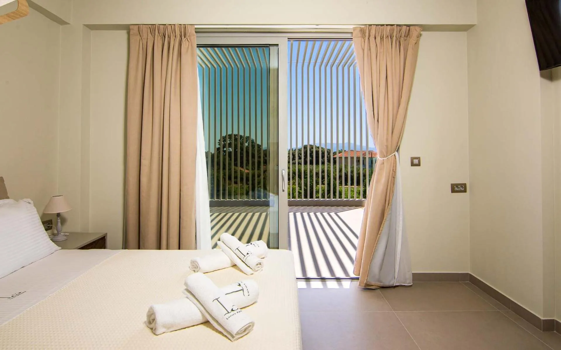 Bed in IO Luxury Pool & Hot Tub Suites