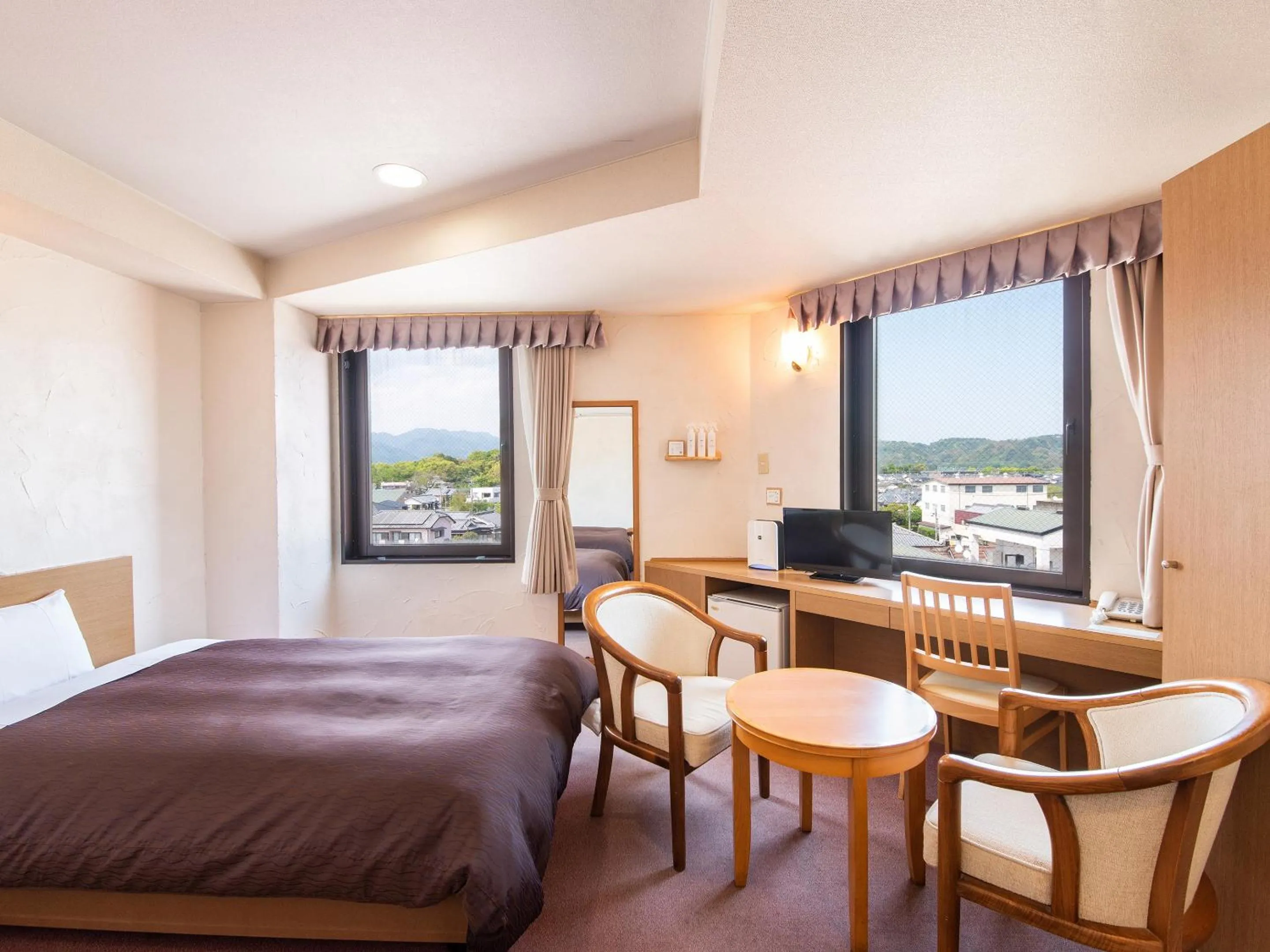 Bed in Hotel Primrose Saito