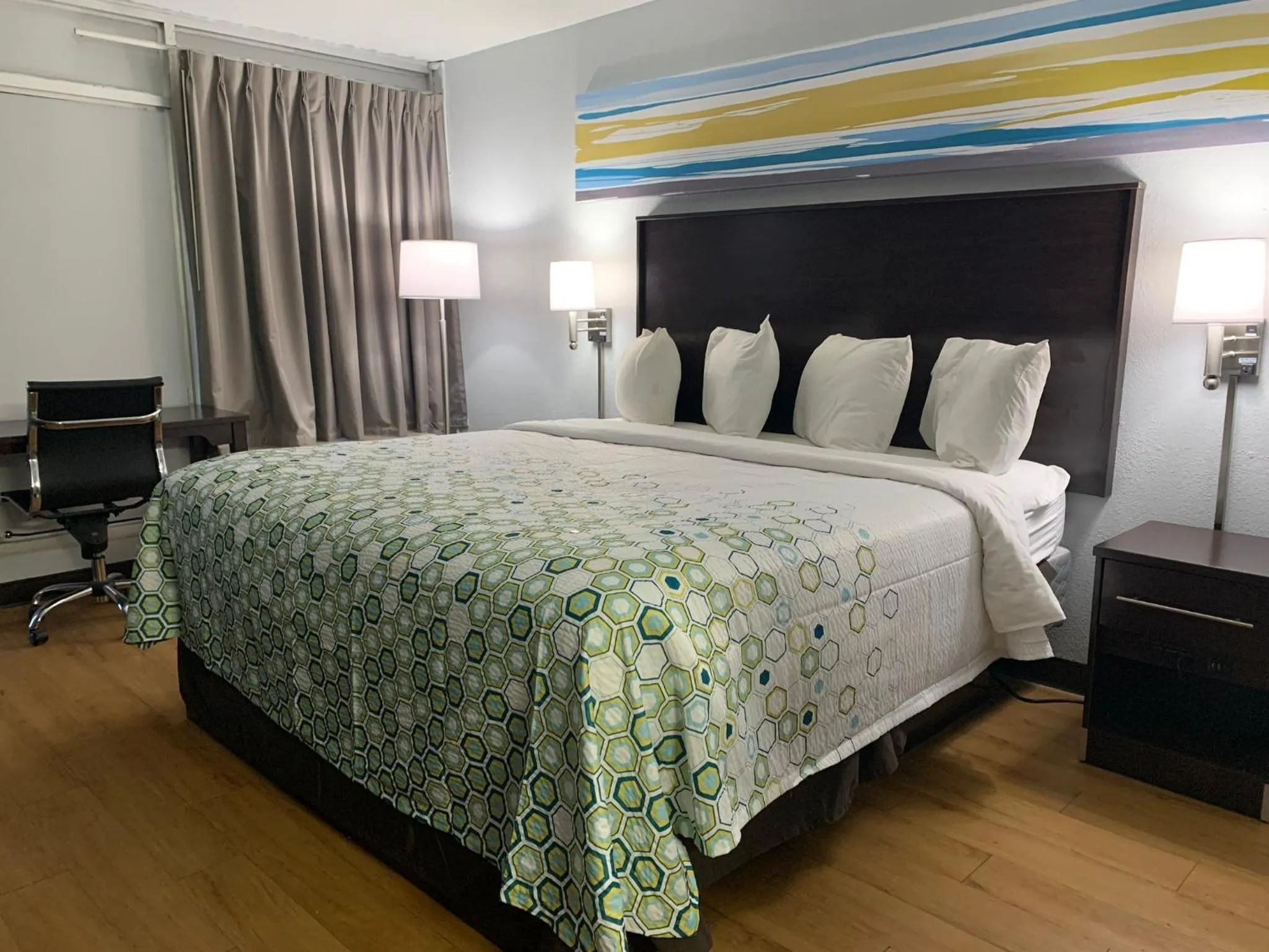 Bedroom, Bed in HomeTowne Studios by Red Roof Battle Creek