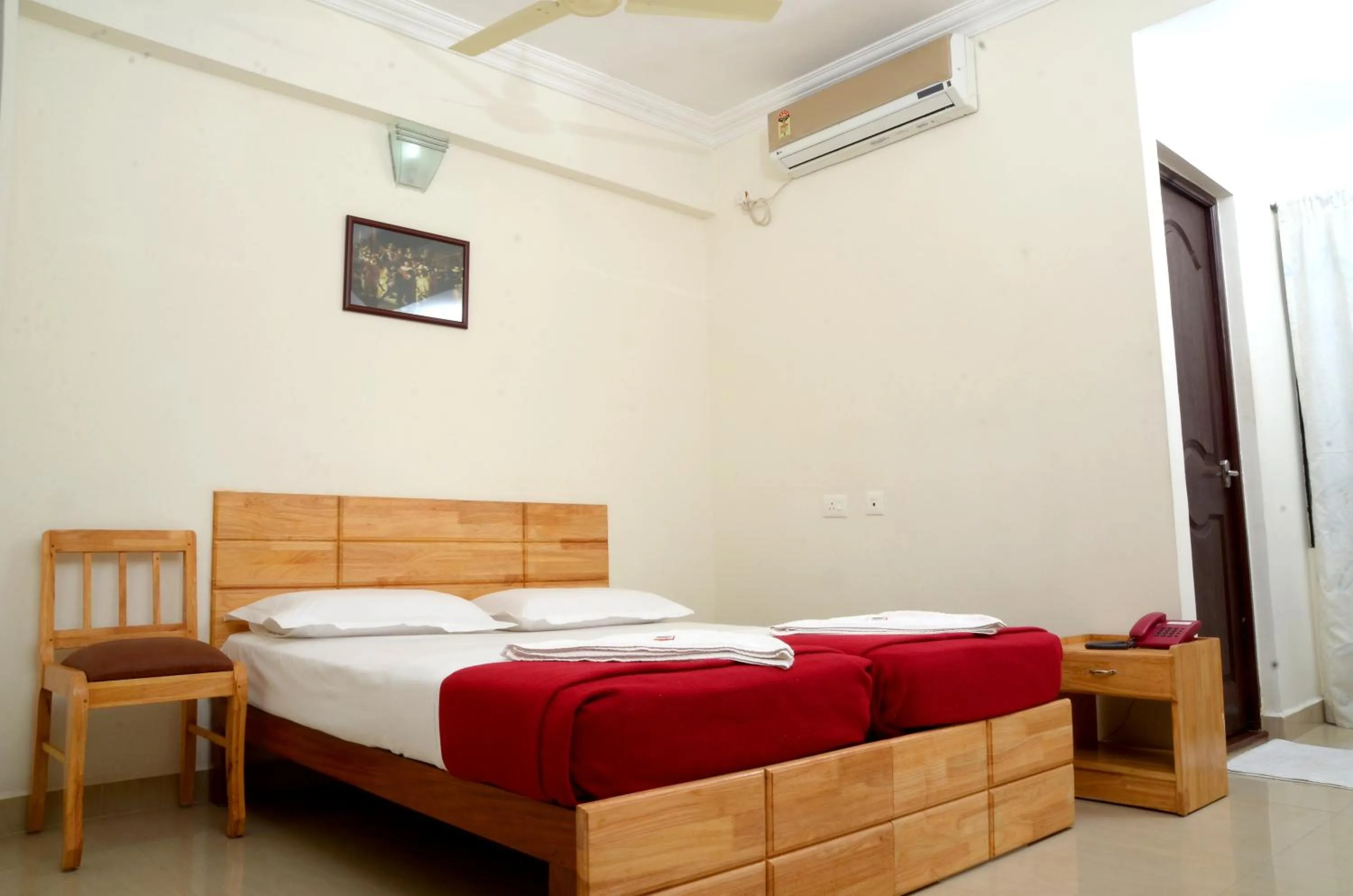 Seating area, Bed in A V Residency