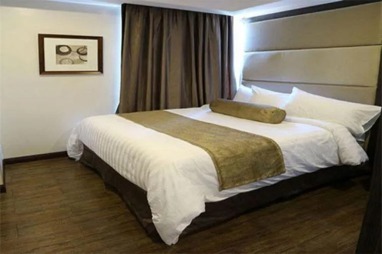 Bed in My Happy Place West Avenue Suites