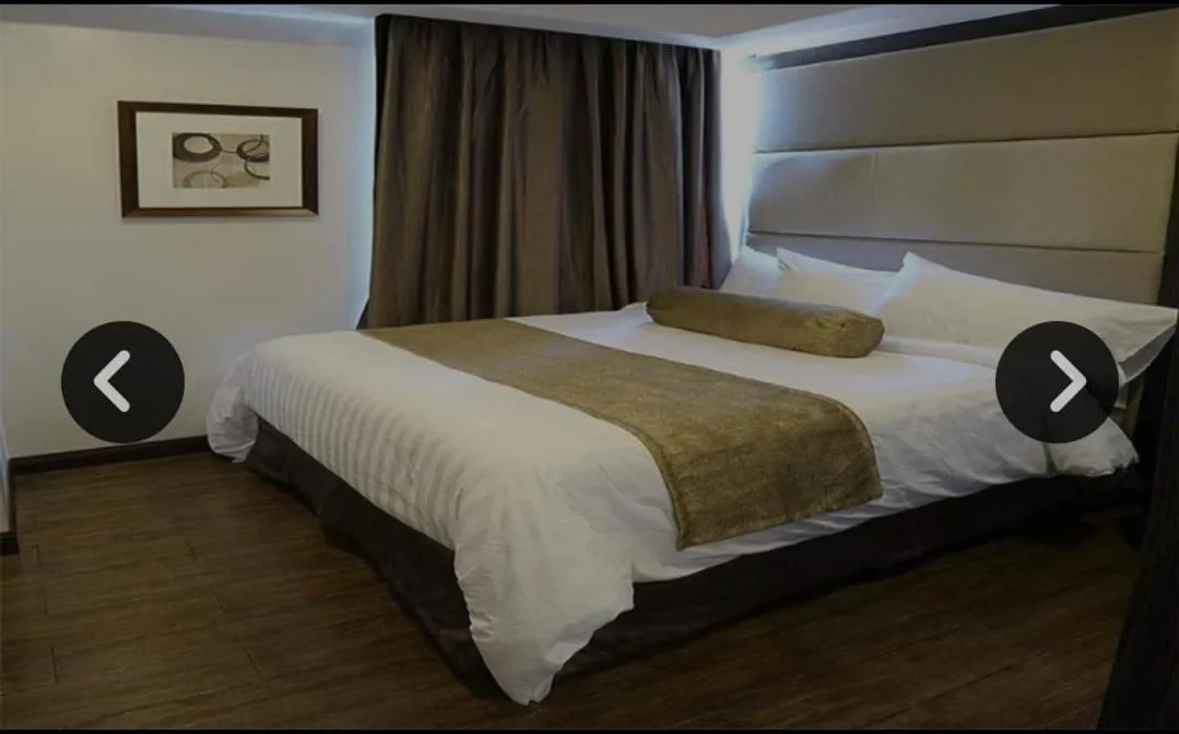 Bed in My Happy Place West Avenue Suites