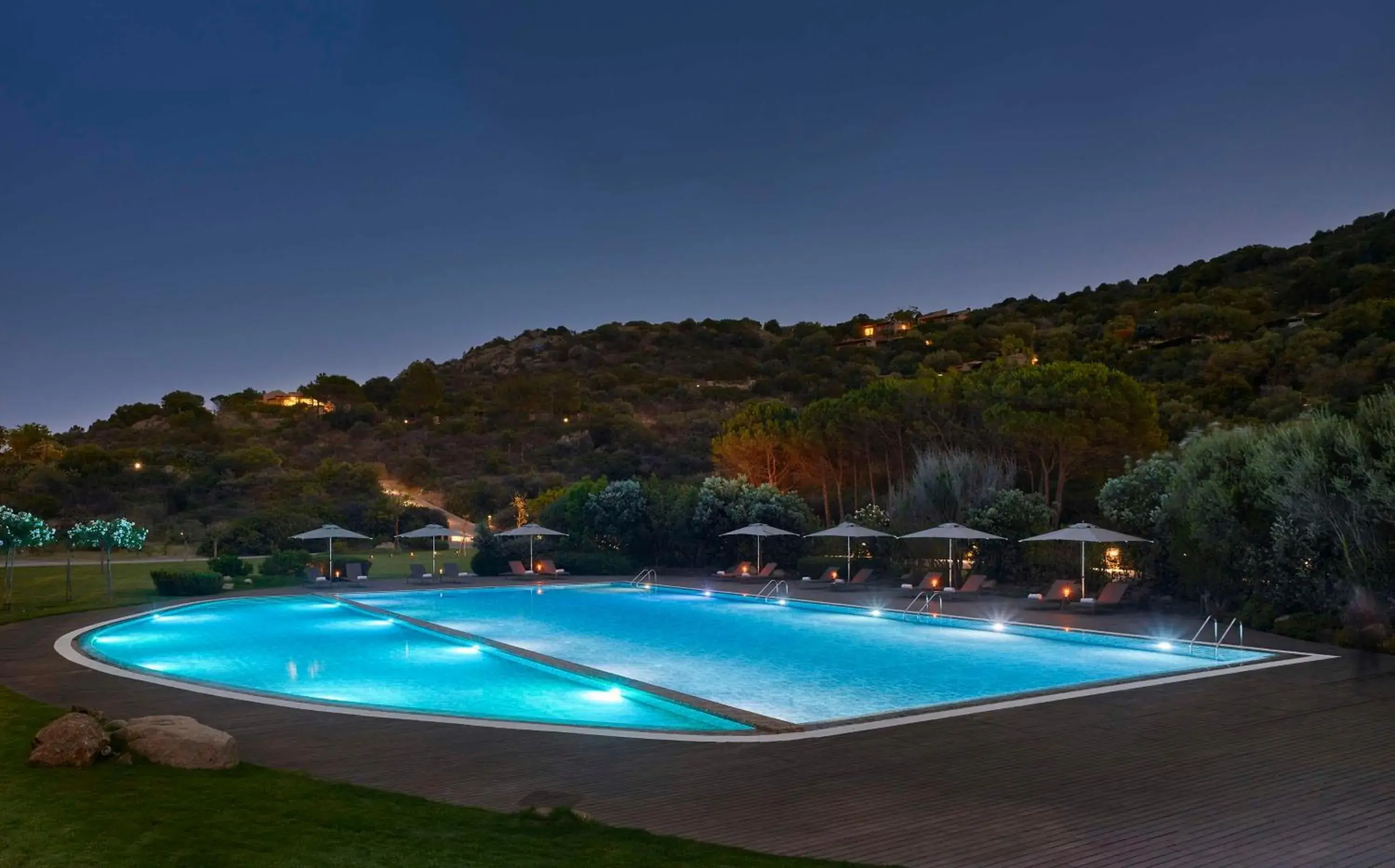 Pool view in Baia Di Chia Resort Sardinia, Curio Collection By Hilton Pool view in Baia Di Chia Resort Sardinia, Curio Collection By Hilton