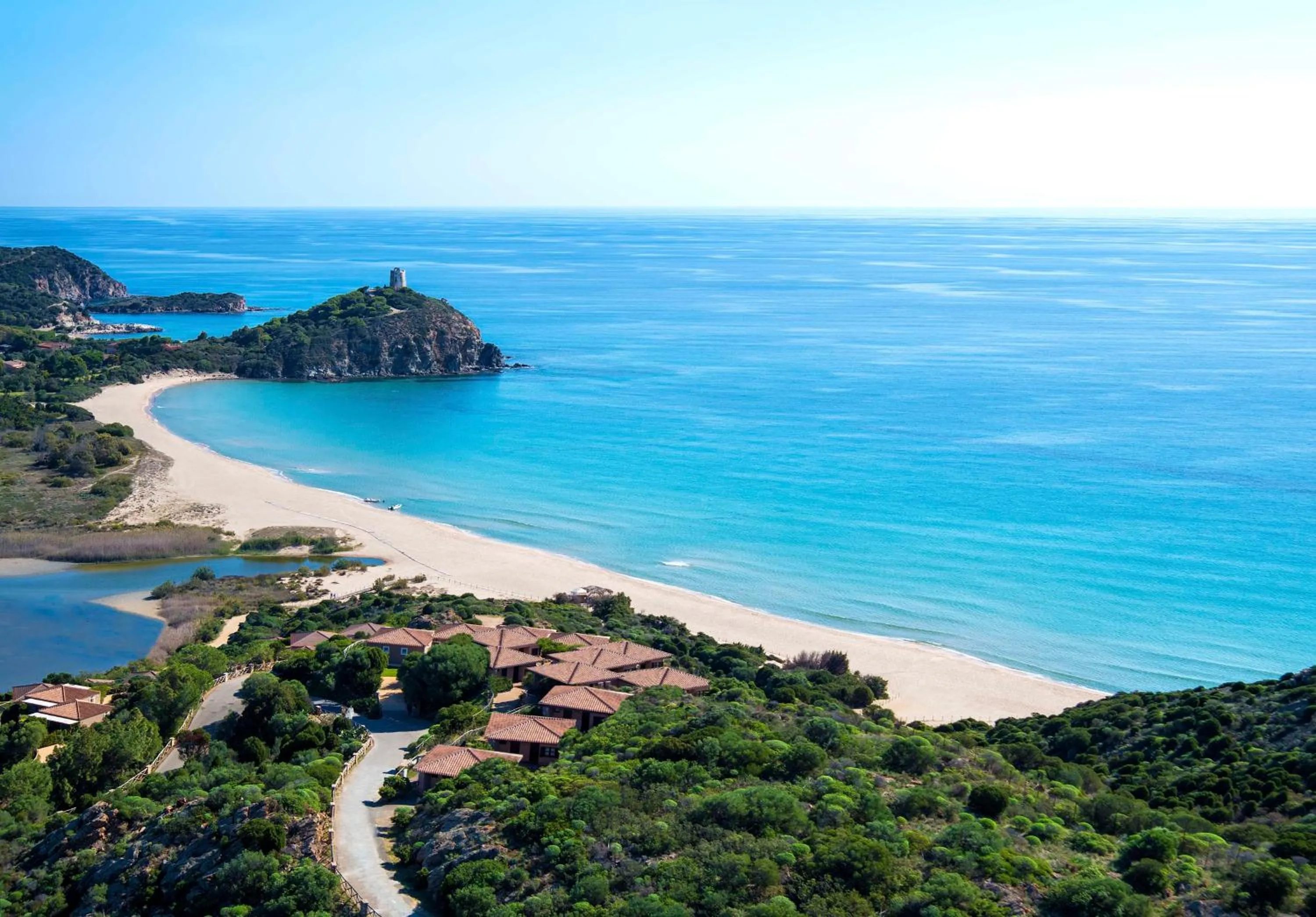 Property building in Baia Di Chia Resort Sardinia, Curio Collection By Hilton