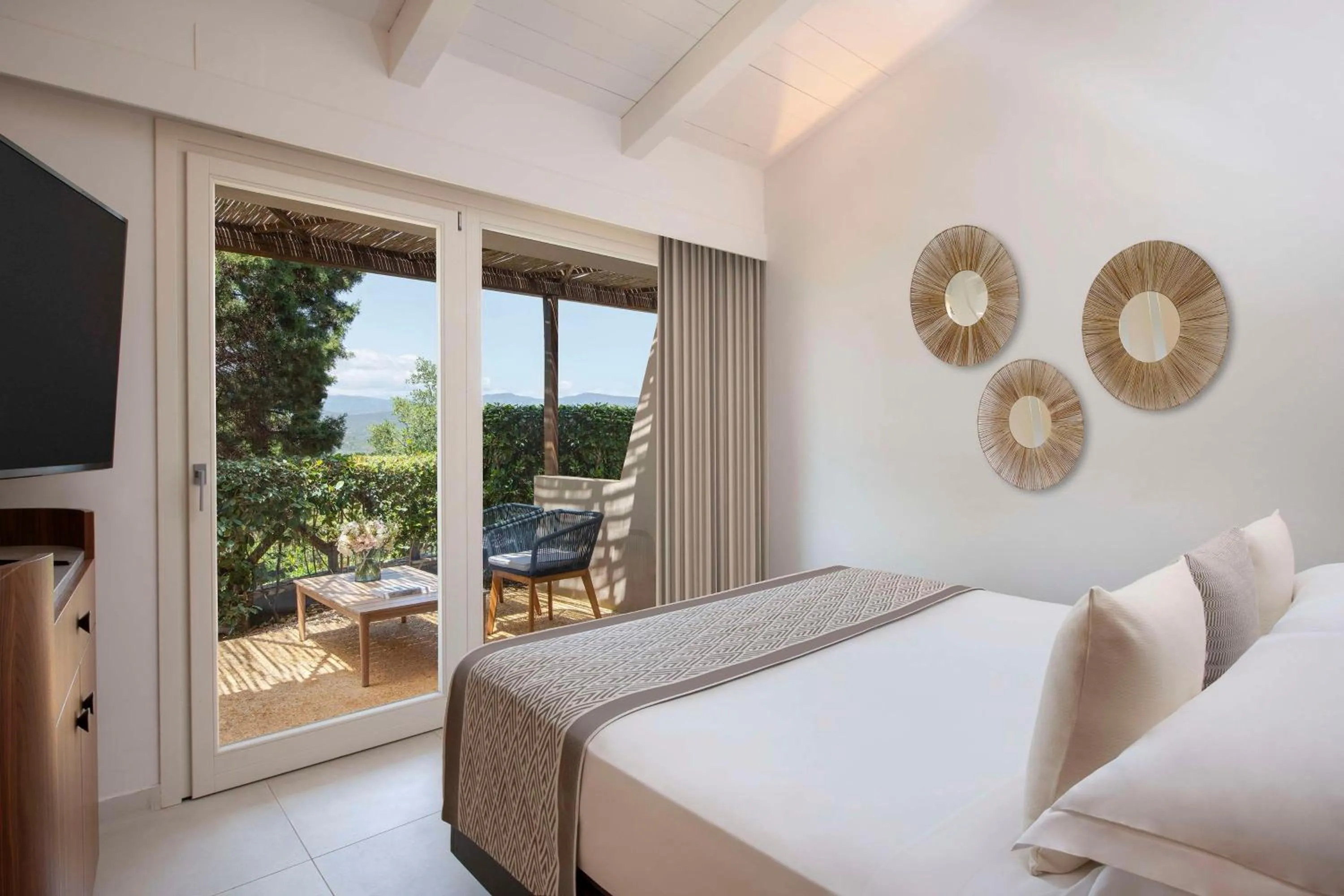 Bed in Baia Di Chia Resort Sardinia, Curio Collection By Hilton
