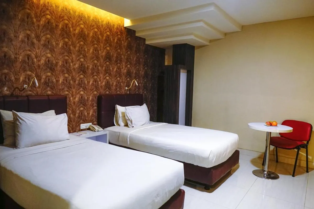 Bed in Empress Hotel Makassar City Center by LIFE