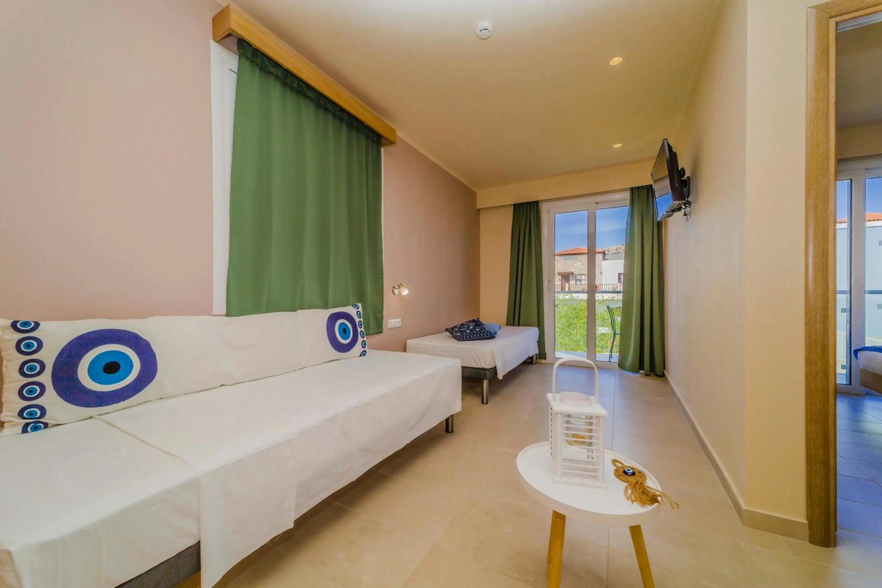 Seating area, Bed in Amaryllis front beach hotel