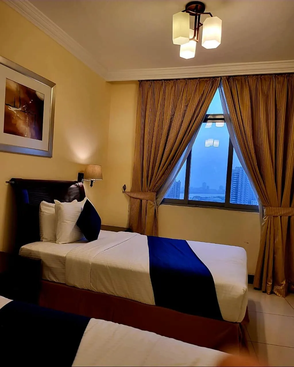 Bed in Crown Palace Hotel