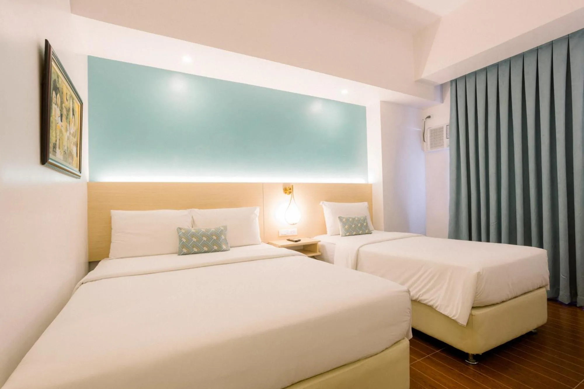 Bed in Allure Hotel & Suites