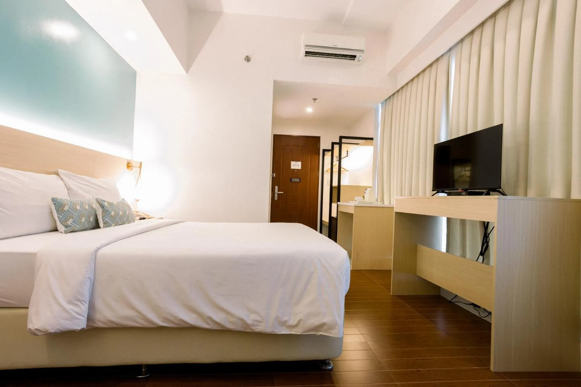 Bed in Allure Hotel & Suites
