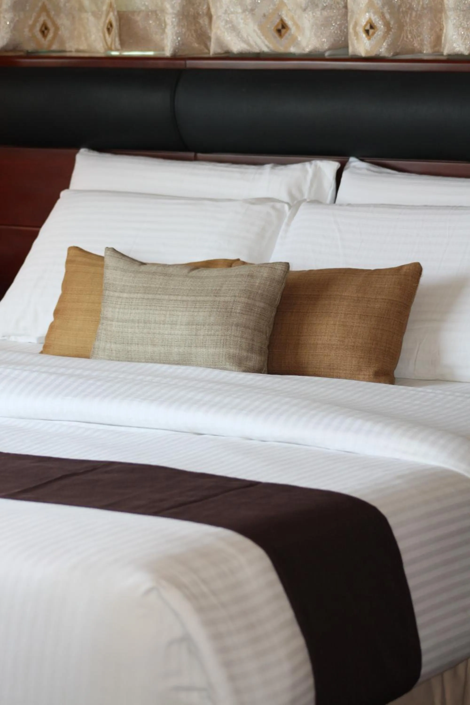 Bed in Allure Hotel & Suites