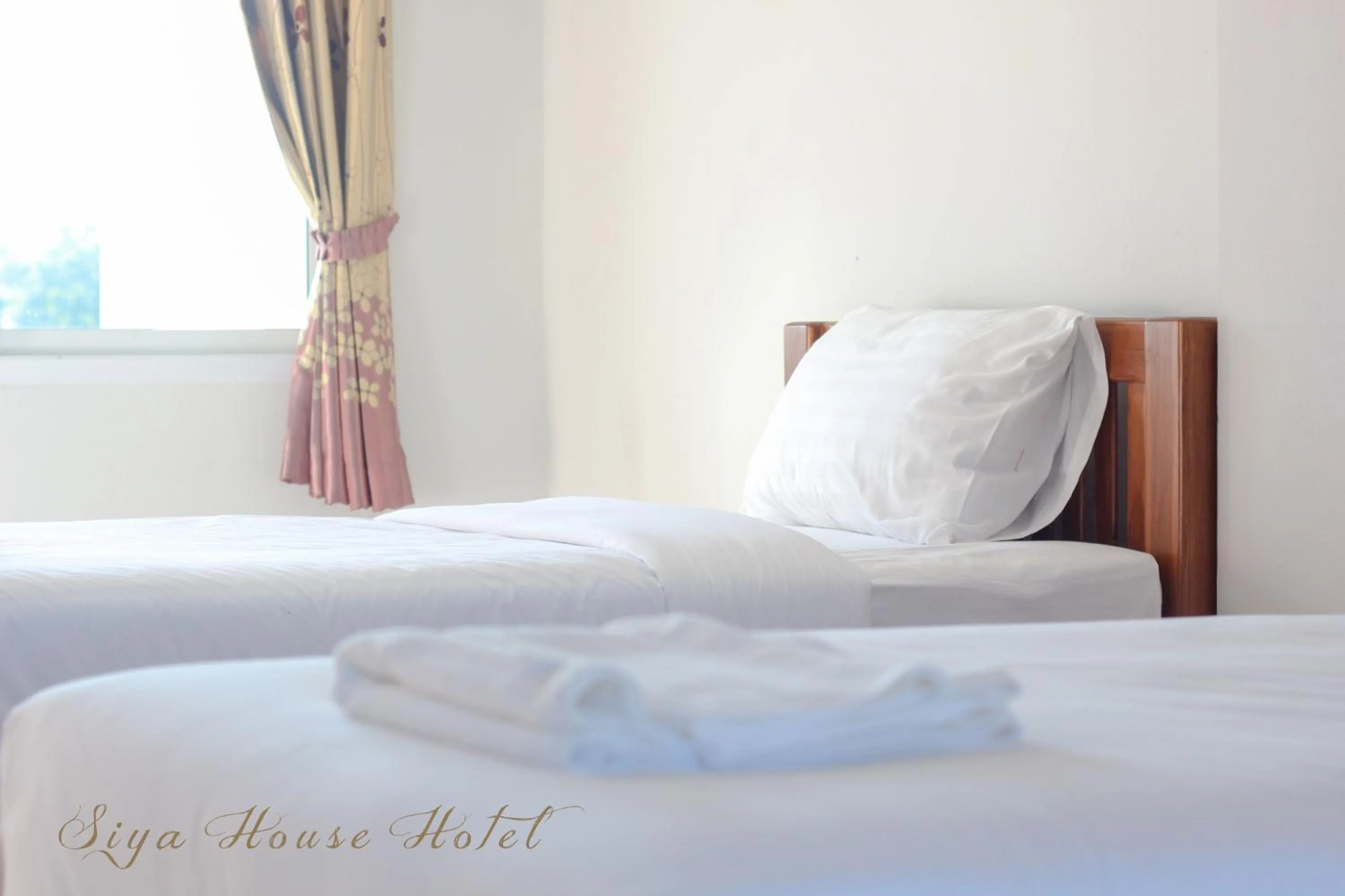 Bed in Siya House Hotel