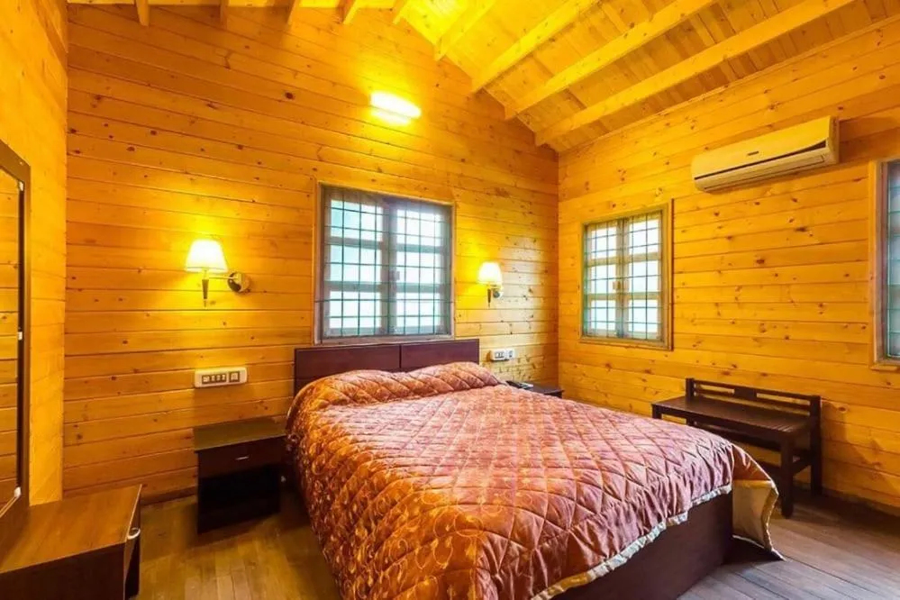 Bed in KRISHNA HERITAGE RESORT