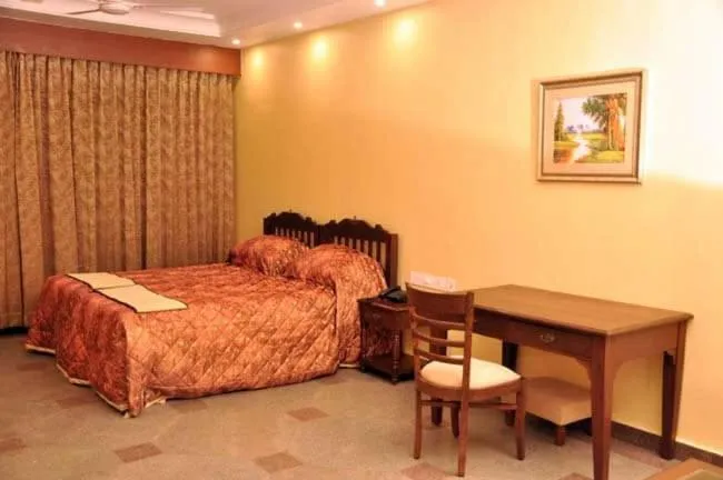 Bed in KRISHNA HERITAGE RESORT