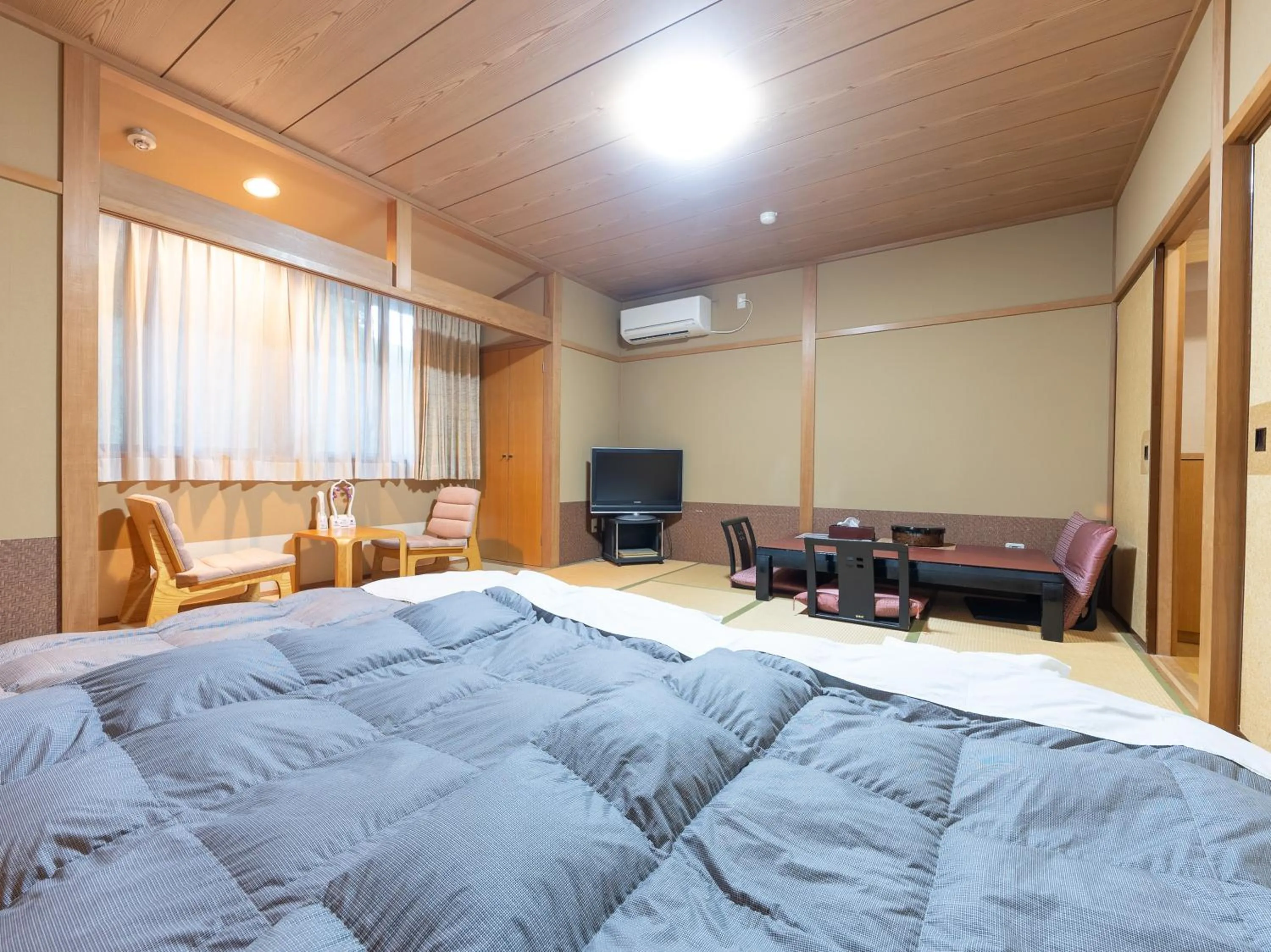 Bed in Tabist Hotel Iyashi no Sato