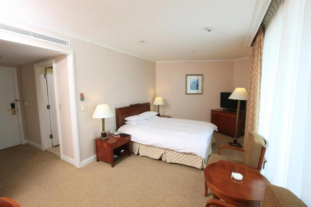 Bed in High1 Palace Hotel and CC